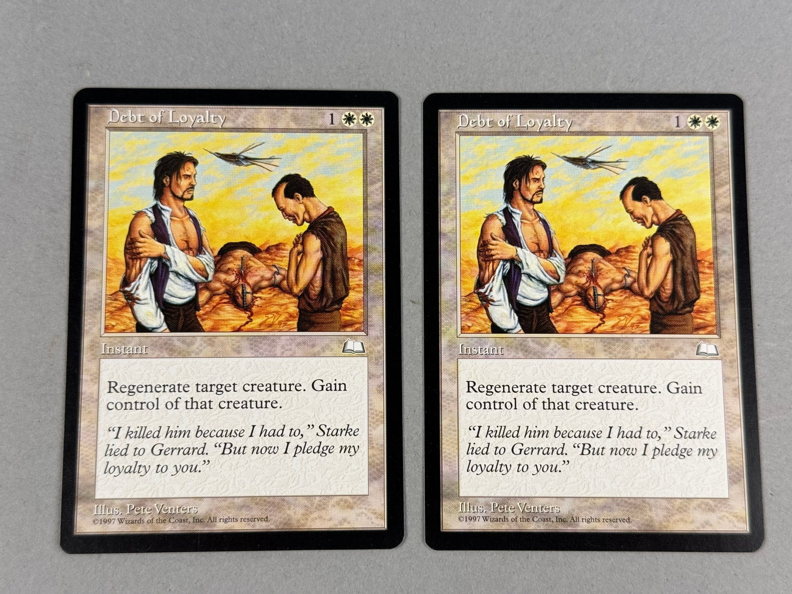 2 Magic The Gathering Debt of Loyalty Weatherlight: This lot contains two original Magic: The Gathering trading cards titled Debt of Loyalty from the Weatherlight expansion set, released in 1997. The bottom edge of each card includes the artist credit