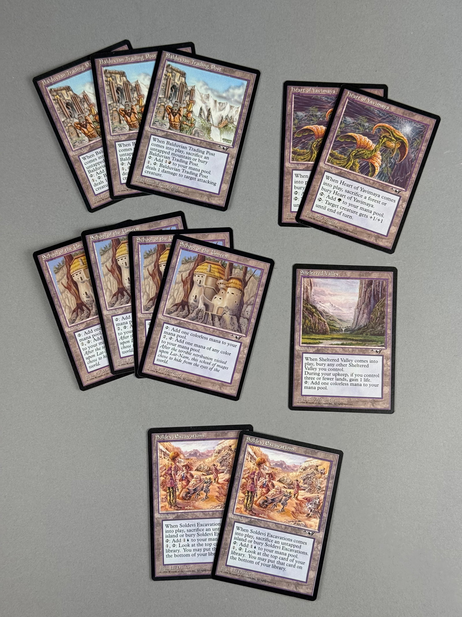 12 Magic: The Gathering Alliances Land Cards: This collection contains 12 original Magic: The Gathering trading cards from the Alliances expansion set, released in 1996 by Wizards of the Coast. The lot features cycle of the set's rare land cards