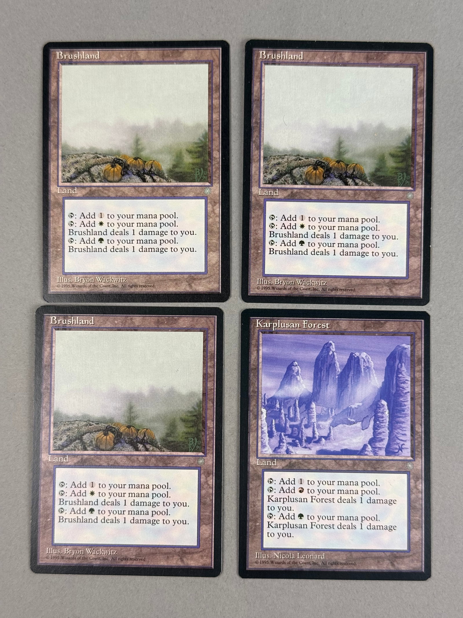 4 Magic: The Gathering Ice Age Lands including Brushland and Karplusan Forest: This collection consists of four rare land cards from the Magic: The Gathering Ice Age expansion set, originally released in 1995. The group contains three copies of the card Brushland and one copy