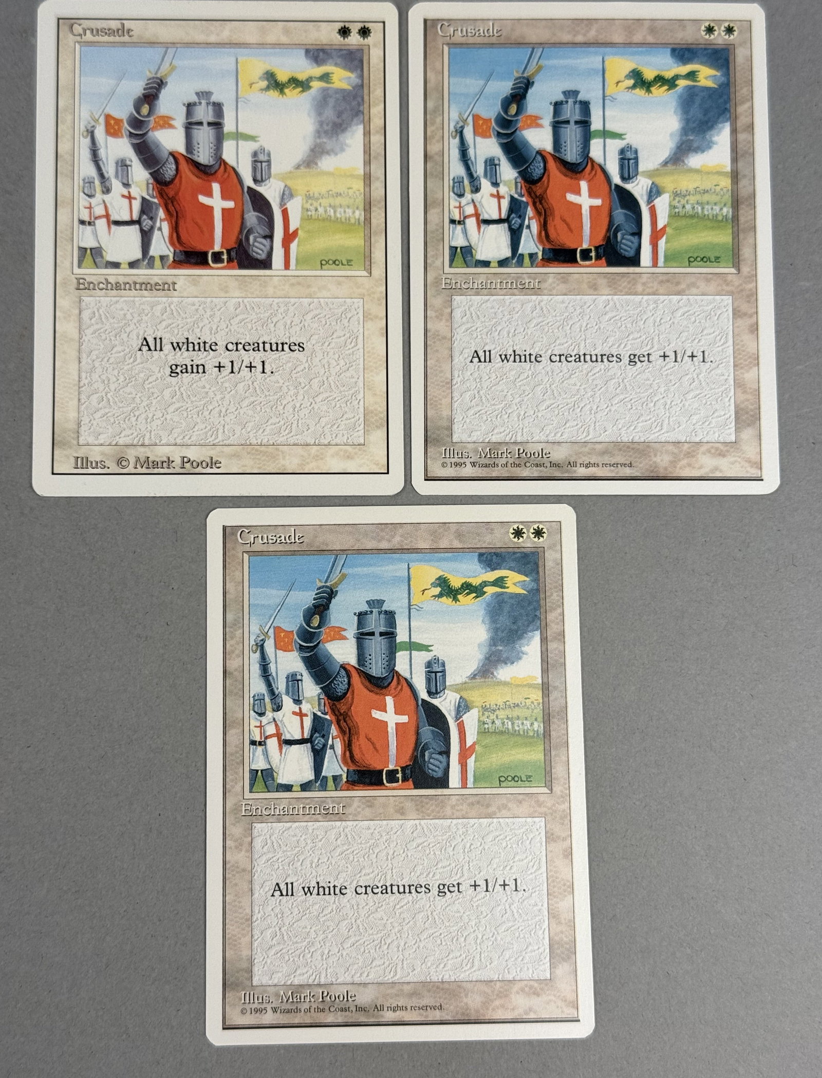 3 Magic The Gathering Crusade Revised and Fourth Editions: This lot consists of three English-language Magic: The Gathering trading cards featuring the rare enchantment Crusade. The collection includes two different vintage print versions from the early 1990s