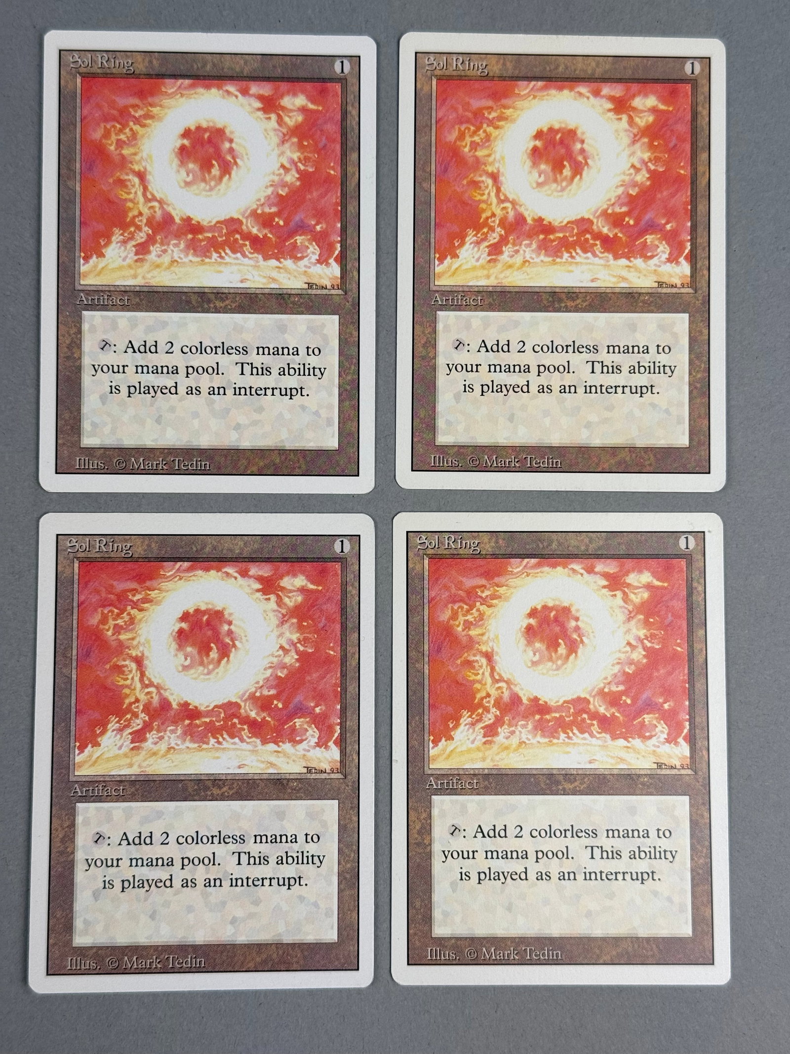 4 Magic The Gathering Revised Edition Sol Ring: This lot consists of a complete playset of four Sol Ring artifact cards from the Magic: The Gathering Revised Edition, also known as Third Edition, released in 1994. Dimensions: 2.5 inches by 3.5 inch