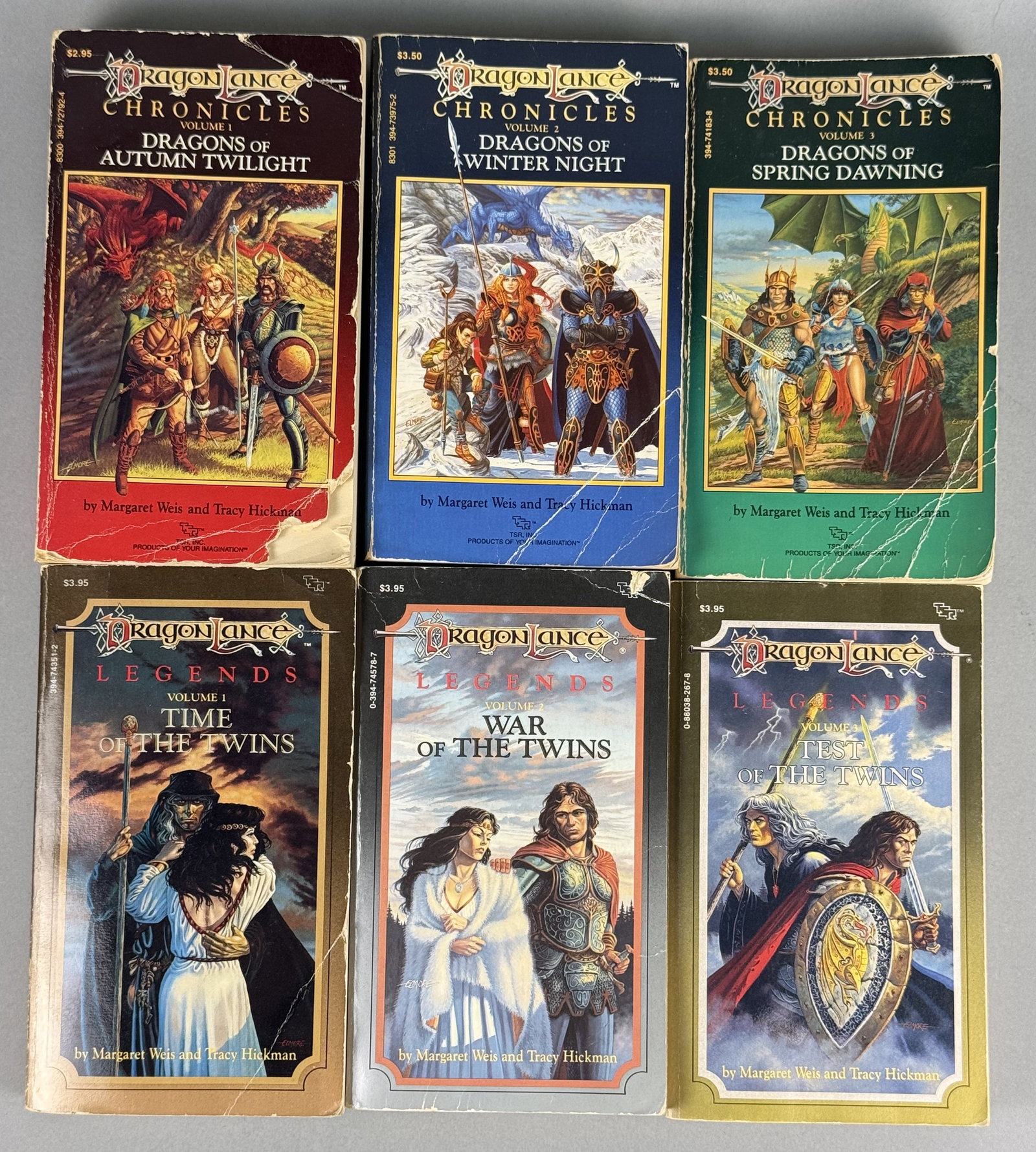4 Dragonlance Chronicles and Legends Books TSR, Inc: A collection of mass-market paperback volumes comprising the complete Dragonlance Chronicles and Dragonlance Legends trilogies. The set includes the titles Dragons of Autumn Twilight, Dragons of