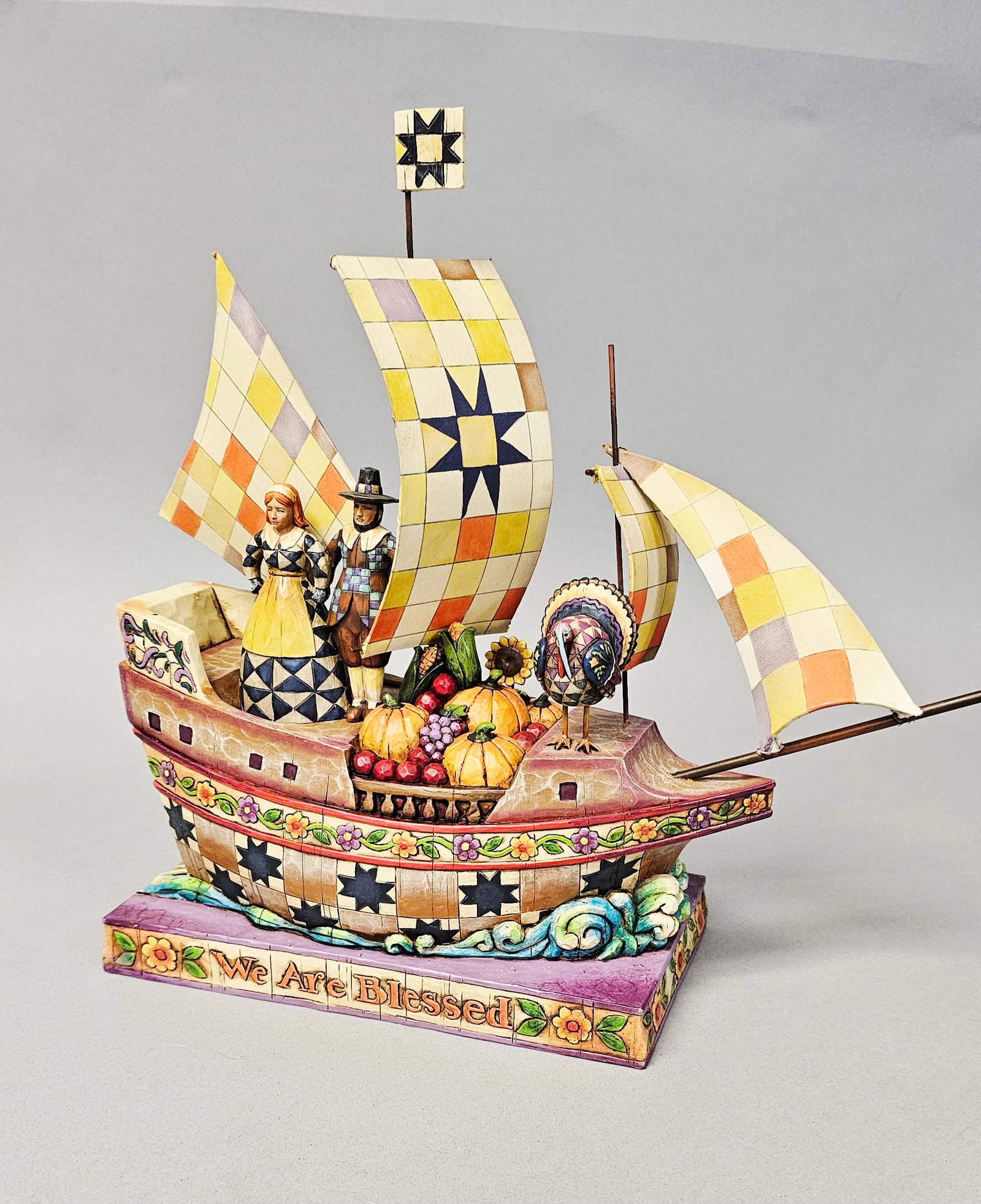 Jim Shore Pilgrim Vessel Figurine Hope Bounty & Joy: A Jim Shore Heartwood Creek decorative figurine titled Seeking Hope, Bounty and Joy, model number 4002860. This large-scale centerpiece is crafted from stone resin, cast and painted in a folk-art styl