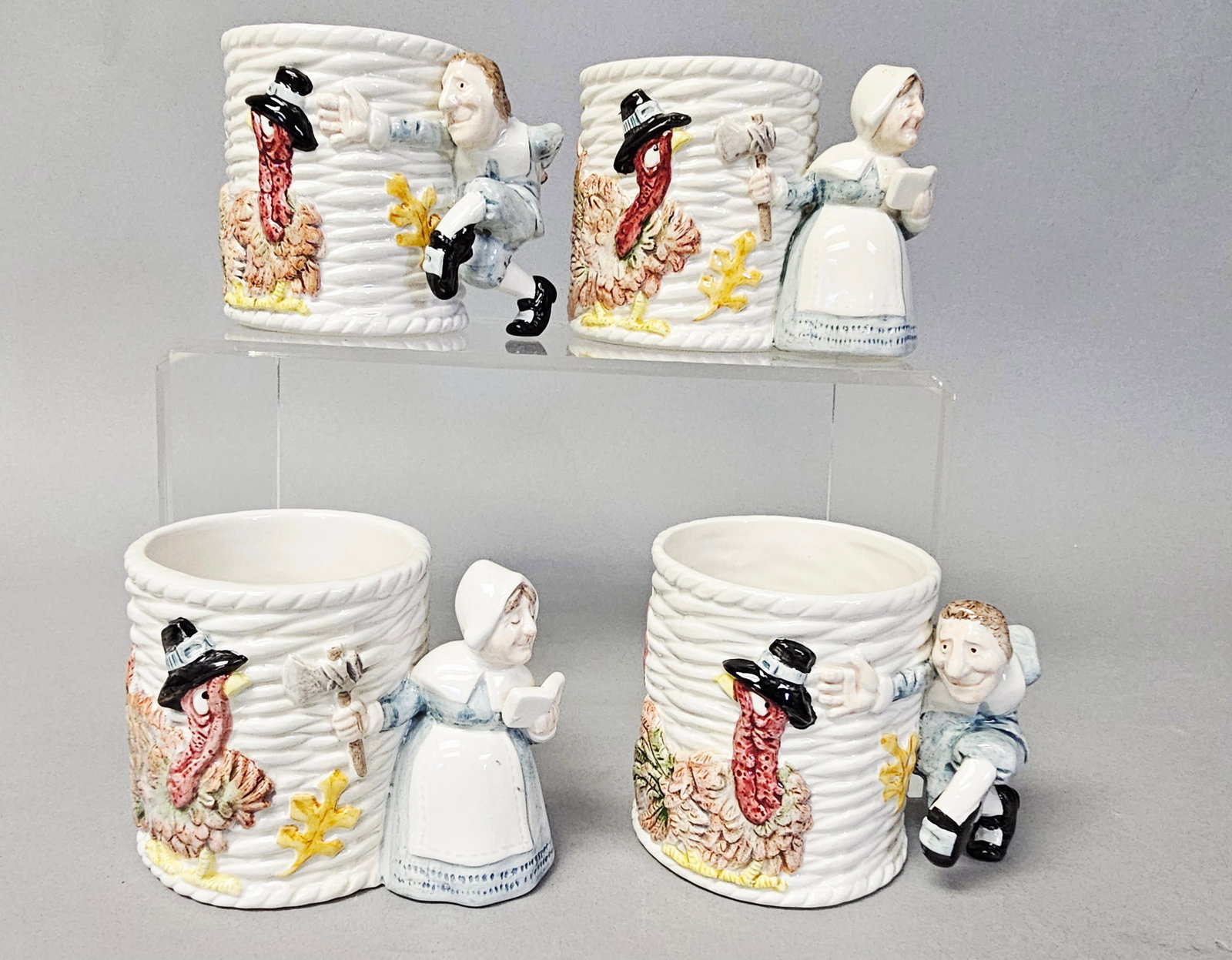 Four Fitz and Floyd Pilgrim's Progress Mugs 1990: This set of four collectible ceramic mugs is produced by Fitz and Floyd in the Pilgrim's Progress pattern. Each mug features a molded rope or basketweave textured body in a creamy white glaze. Each mu