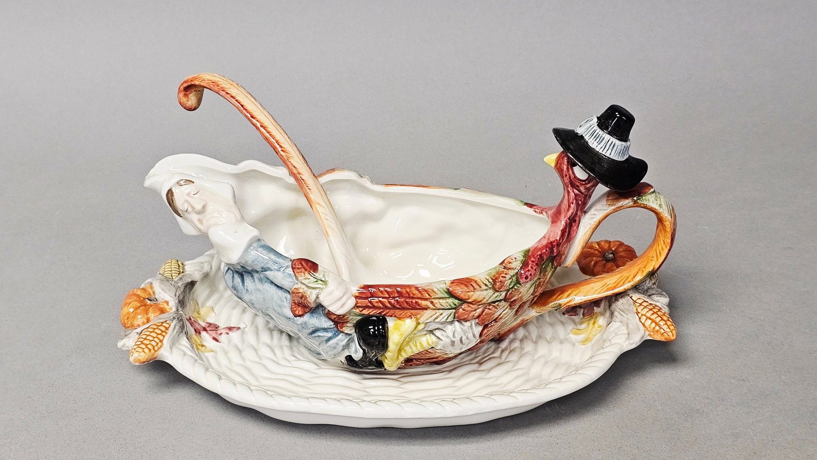 Fitz and Floyd Pilgrim's Progress Sauce Boat Set: A three-piece glazed polychrome ceramic sauce boat set manufactured by Fitz and Floyd in the Pilgrim's Progress pattern. The set consists of a figural sauce boat, a coordinating oval stand, and a