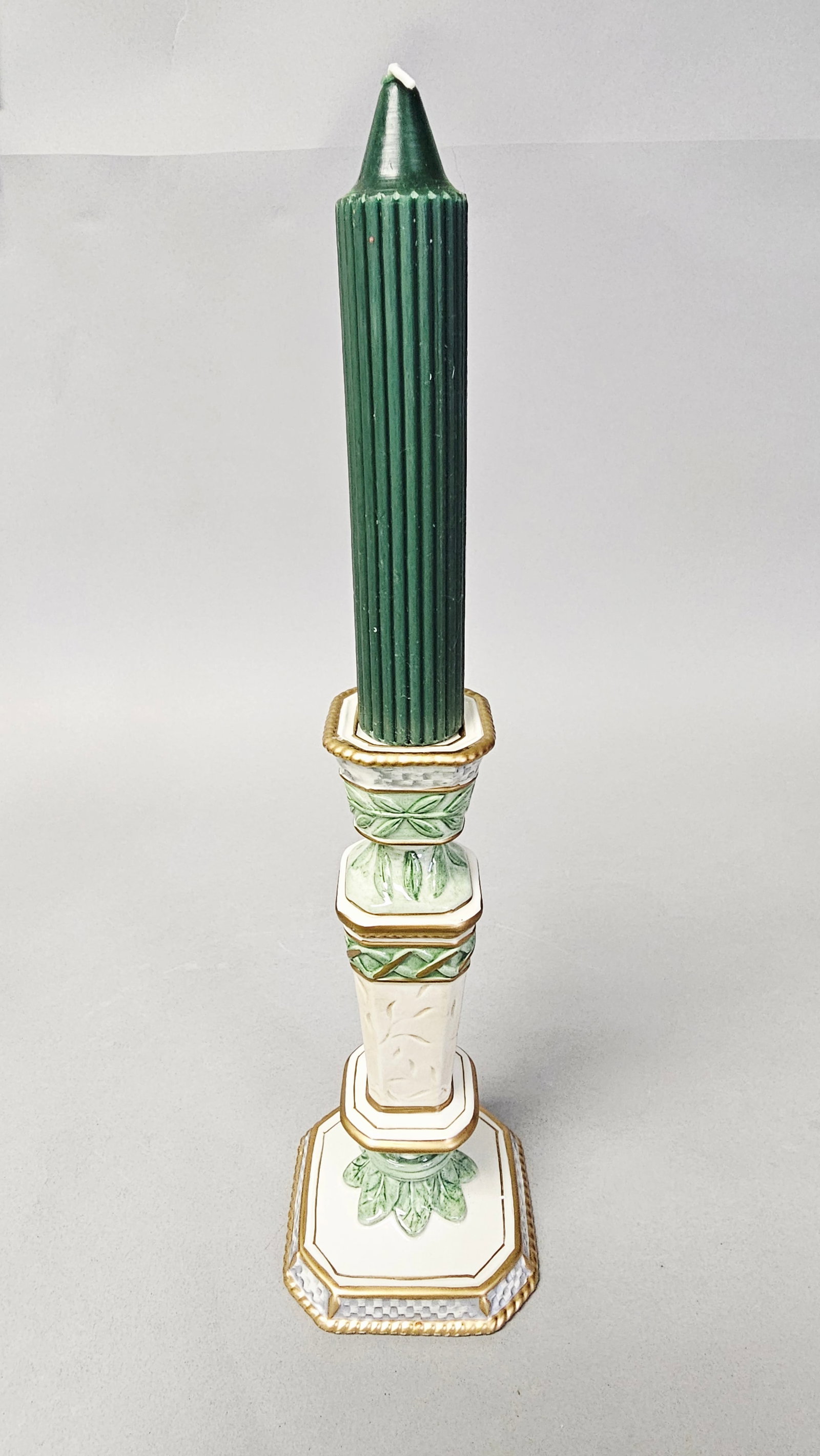 Fitz and Floyd Classics Gregorian Pattern Candleholder: A Fitz and Floyd Classics ceramic candleholder in the Gregorian pattern. The item features a Neoclassical form with an octagonal stepped base, a tapering column, and an octagonal candle cup. The