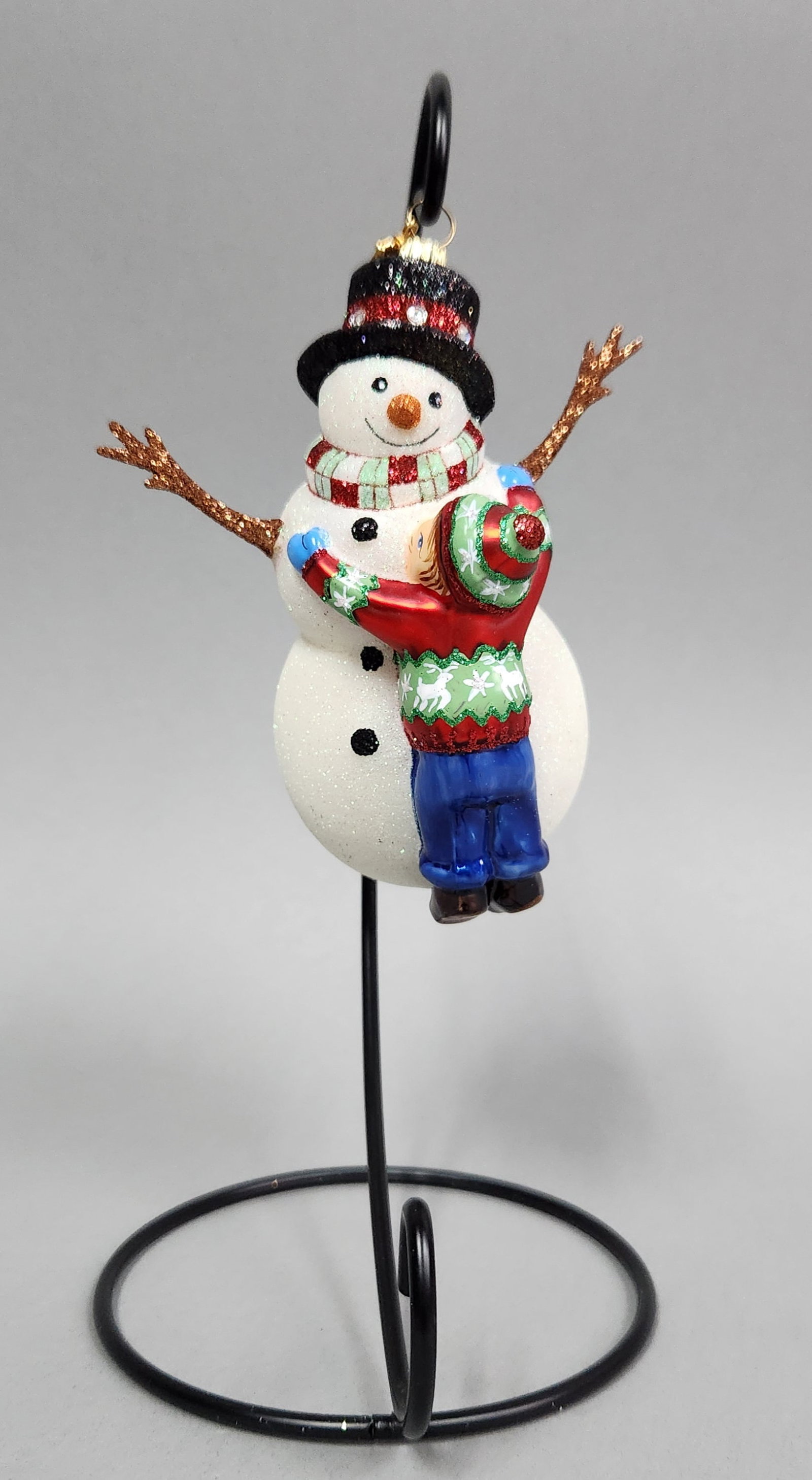 Reed & Barton Snowman Hugs #C3203: Stand not included. Reed & Barton hand-painted glass Christmas ornament from the Fine Handmade European Ornaments collection, titled Snowman Hugs, item number C3203. The original box is included. The