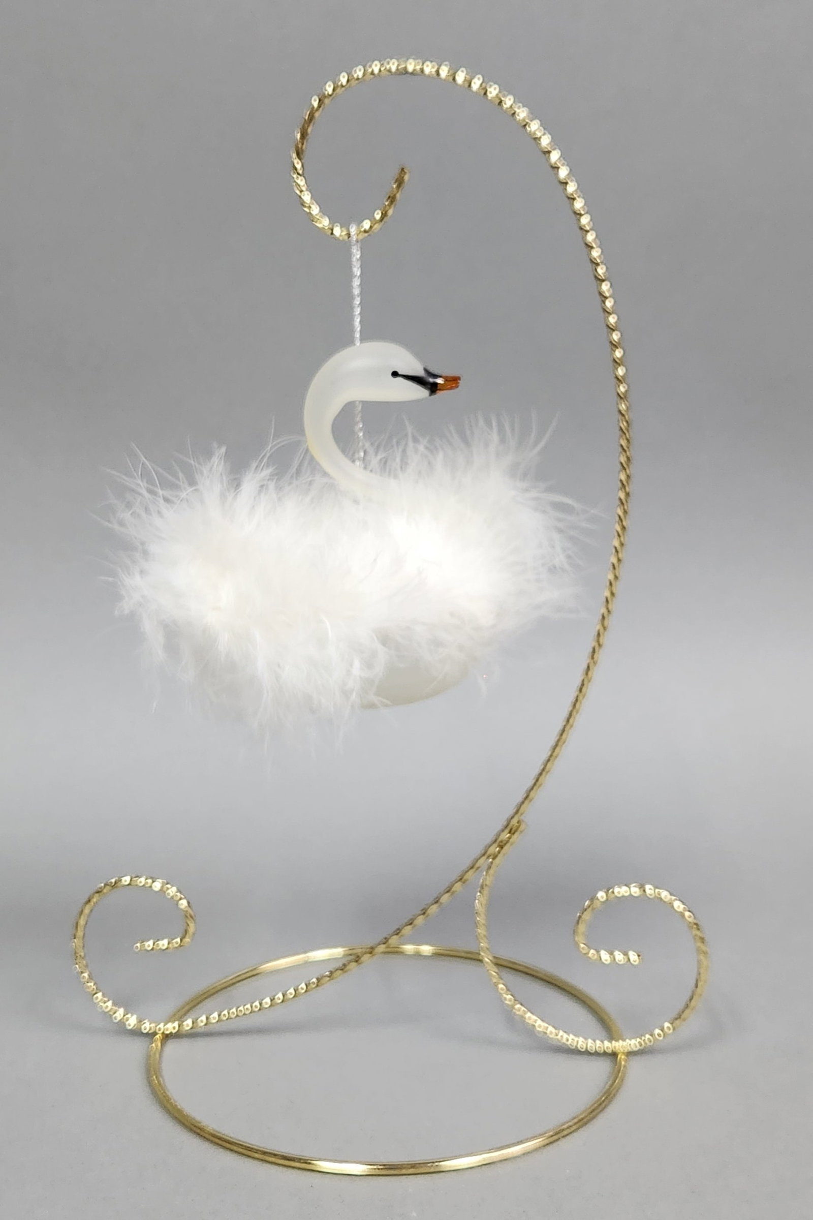 Italian Glass Swan Ornament: Stand not included. A frosted white glass swan ornament from Italy featuring a marabou feather body and amber beak, measuring approximately 4 inches wide. Very good condition.