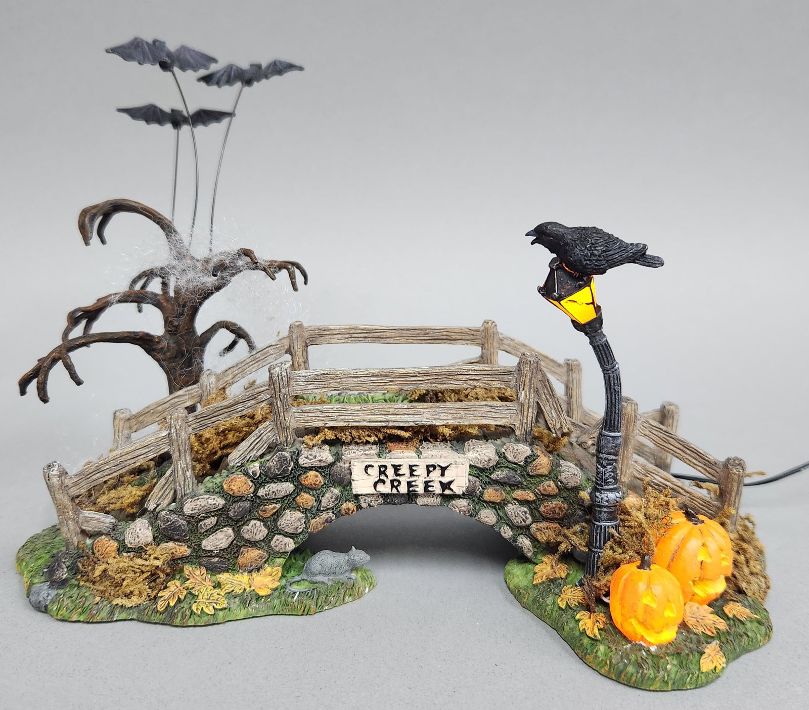 Dept 56 Creepy Creek Bridge #56.53071: This is a Creepy Creek Bridge accessory from the Department 56 Halloween Village collection, model number 56.53071. Width: approximately 9 inches (22.8 cm). Batteries and adapter not included. The