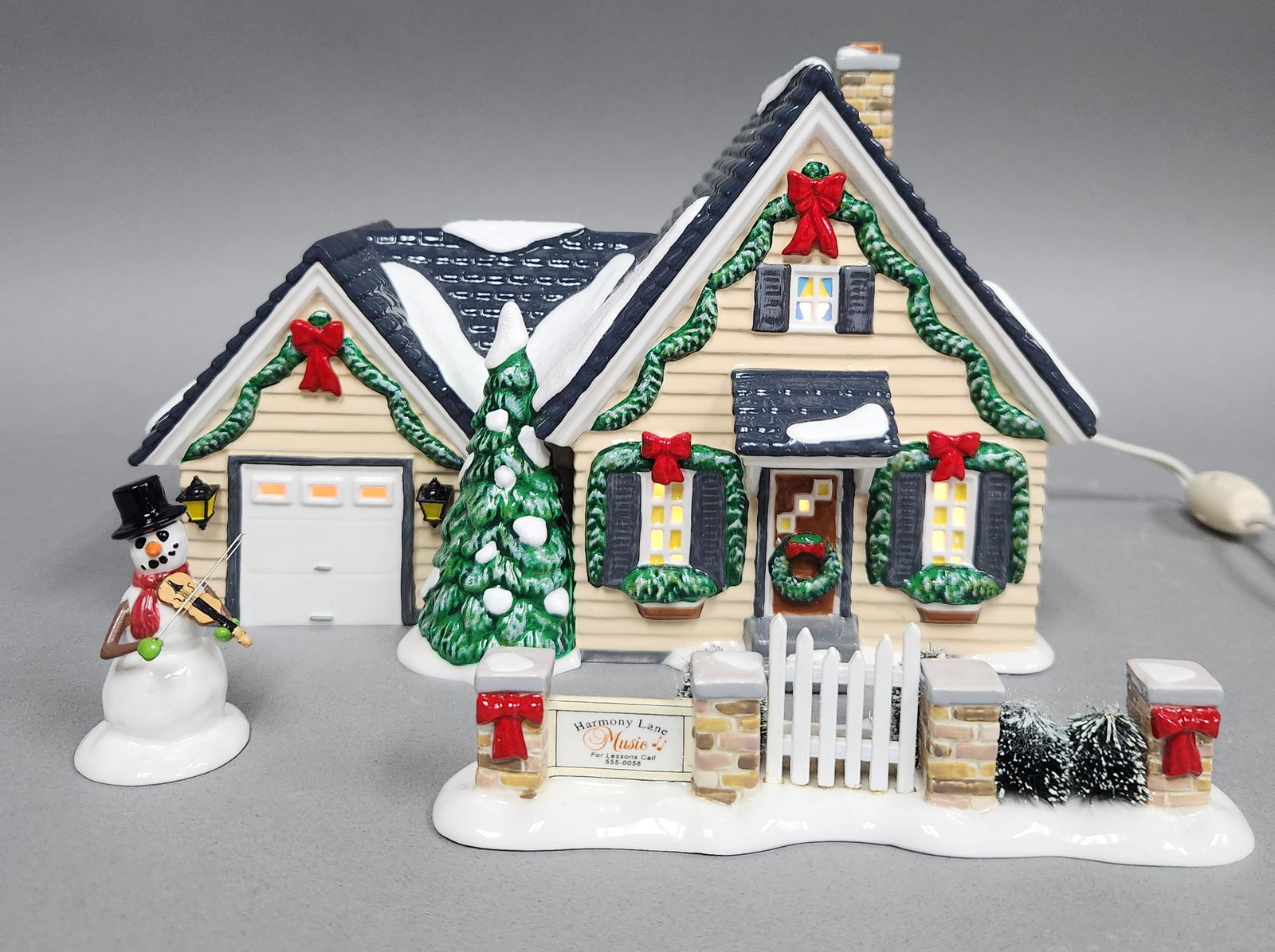 Dept 56 Harmony House Set: This Department 56 The Original Snow Village three-piece ceramic set, titled Harmony House (item number 56.55302), consists of a music teacher's residence and the coordinated Snowman Sonata and Fence 