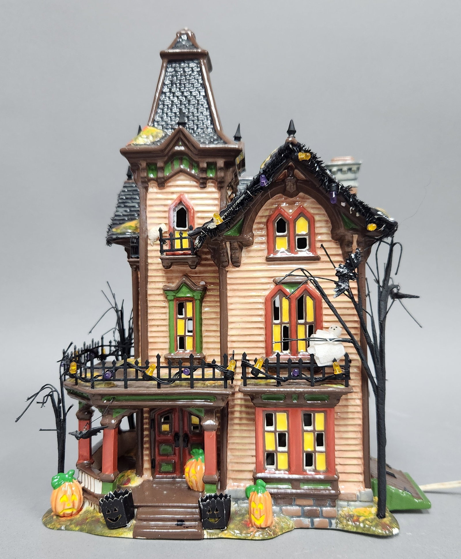 Dept 56 Gothic Haunted House: Department 56 Halloween Victorian House model 56.54601. The ceramic finial at the peak of the tower is broken and missing, leaving a small exposed white base. Minor paint loss and scuffing are