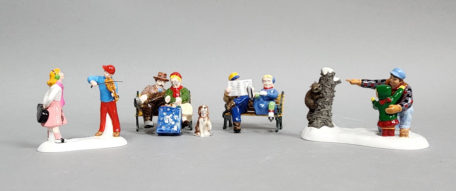 Dept 56 Snow Village Figurines: The collection includes the Violin Serenade set (#56.55169), Hiking In The North Woods set (#56.55133), Sitting In The Park set (#56.55100) and Wrought Iron Park Benches (#56.52851). Figures range fro