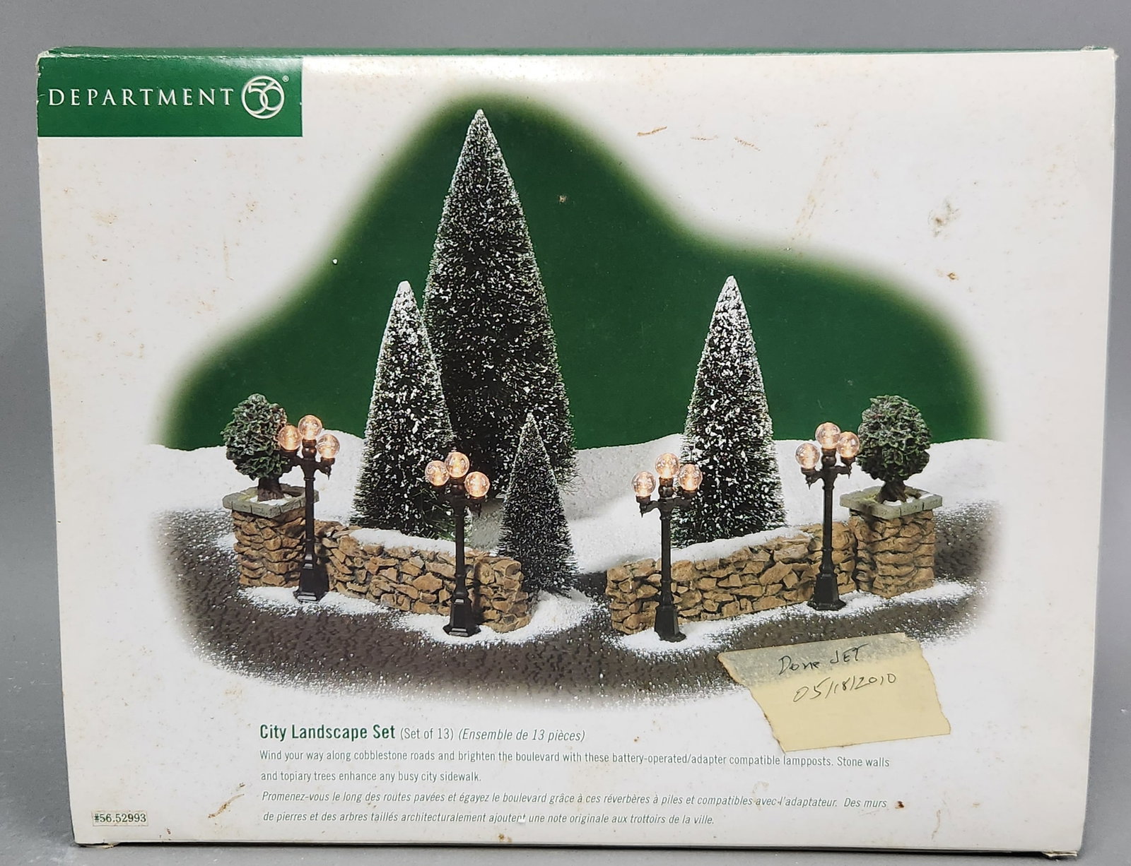 Dept 56 City Landscape #56.52993: A Department 56 City Landscape Set, model number 56.52993.Set includes four frosted evergreen trees of varying heights, four lampposts equipped for battery or adapter power, and several stone wall