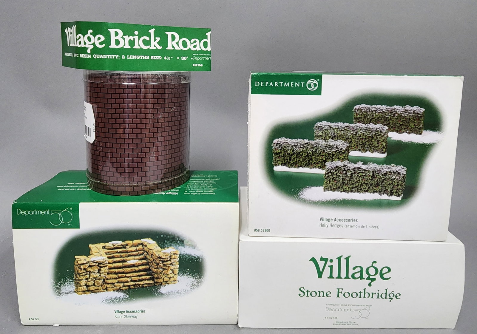 More Dept 56 Village Accessories: The group includes Village Brick Road, a Stone Stairway, 2 Holly Hedges, and a Stone Footbridge. Missing 2 of the hedges. Overall good condition.