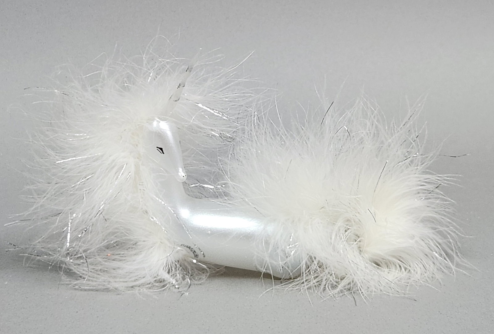 Italian Glass Unicorn Ornament: Stand not included. This iridescent white blown-glass unicorn features white feather and silver tinsel accents and measures approximately 7.5 inches in length. Very good condition.