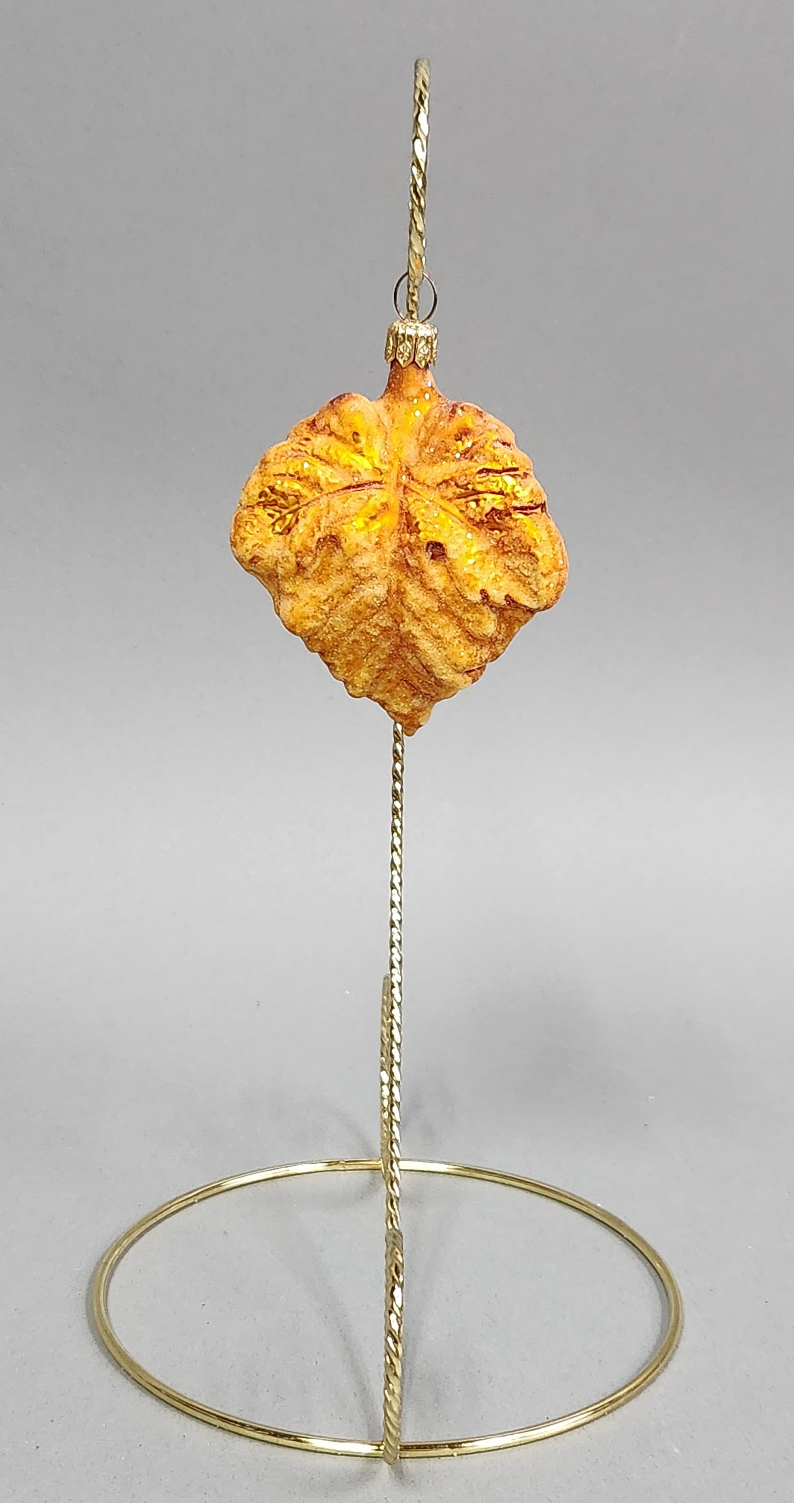 Christopher Radko Orange Leaf Ornament: Stand not included. A Christopher Radko golden orange leaf-shaped glass Christmas ornament with glitter accents, measuring approximately 3.5 inches in length. Very good condition.
