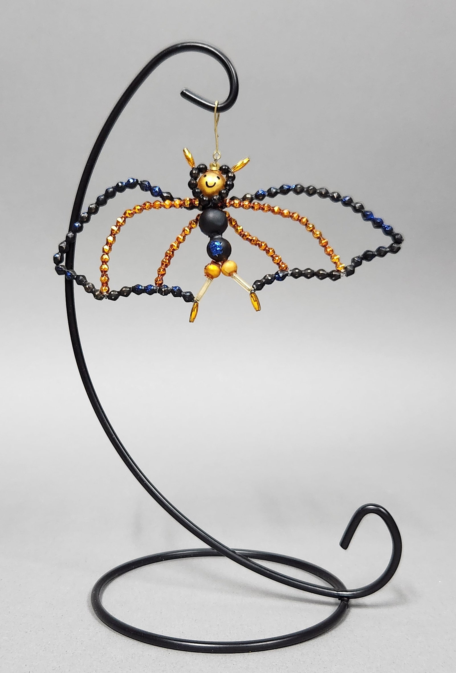 Christopher Radko Ding-Bat Ornament: Stand not included. Christopher Radko glass beaded bat ornament. Wingspan: approximately 5.75 inches. The ornament is in good overall condition. No missing beads or broken wires are observed. The