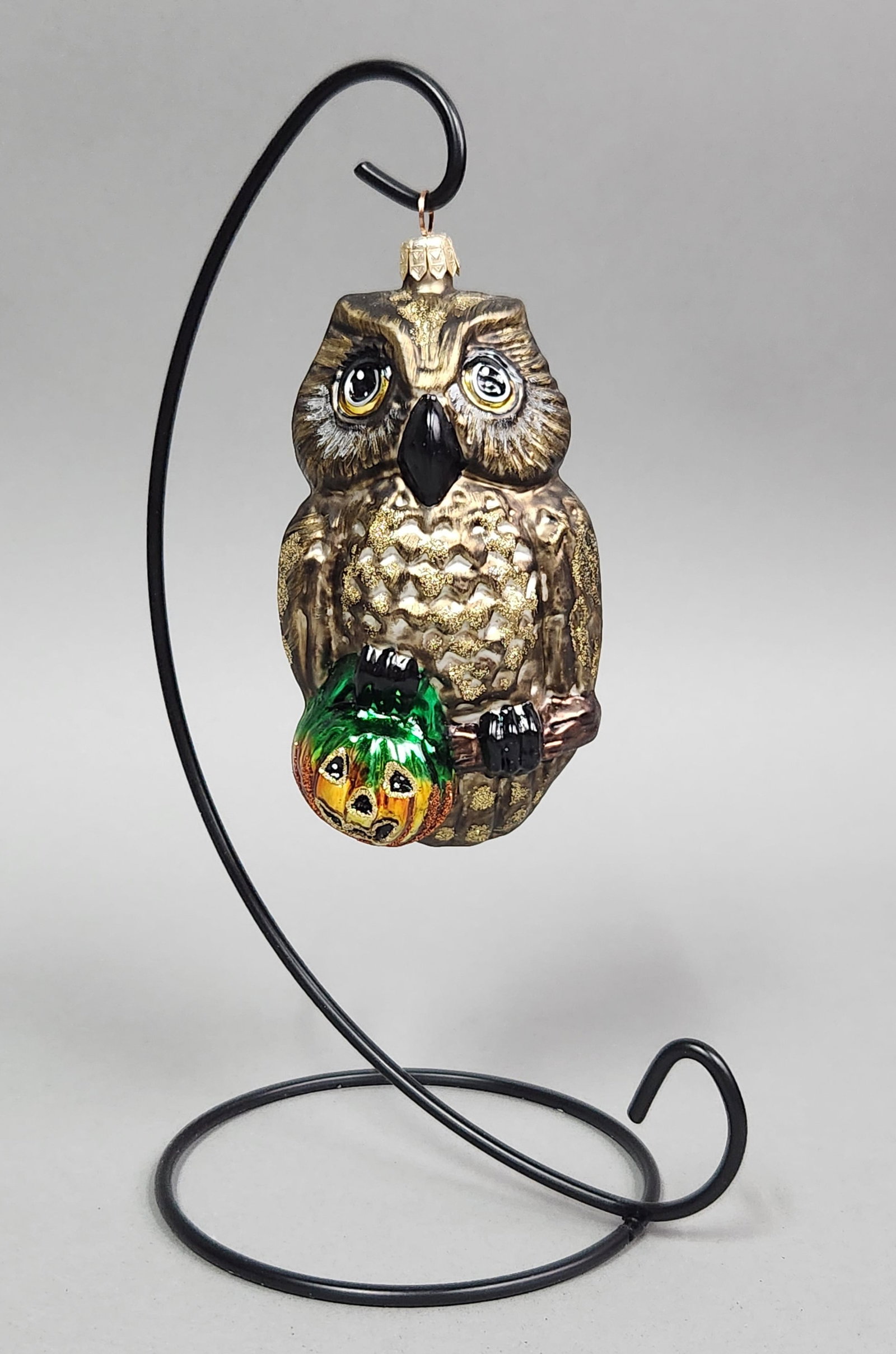 Owl and Jack-o-Lantern Ornament: Stand not included. A hand-painted glass Christmas ornament depicting an owl perched on a branch holding a jack-o-lantern, featuring a gold-tone cap marked Made in Poland and measuring approximately