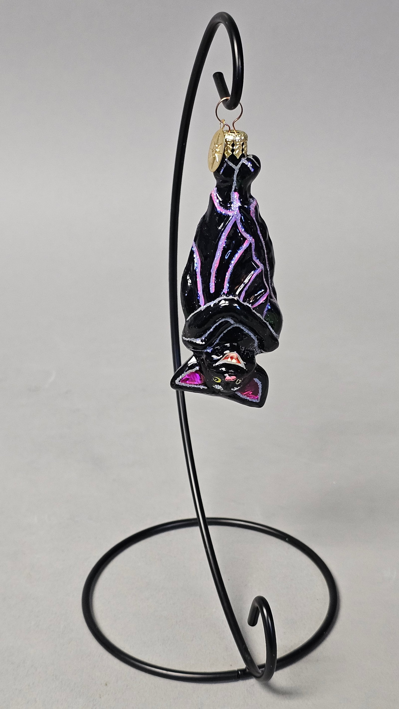 Radko Disney Villains Maleficent Bat Glass Ornament: *STAND NOT INCLUDED* This is a Christopher Radko hand-blown glass ornament depicting the bat character from the Disney Villains collection. The ornament is finished in a glossy black glaze with