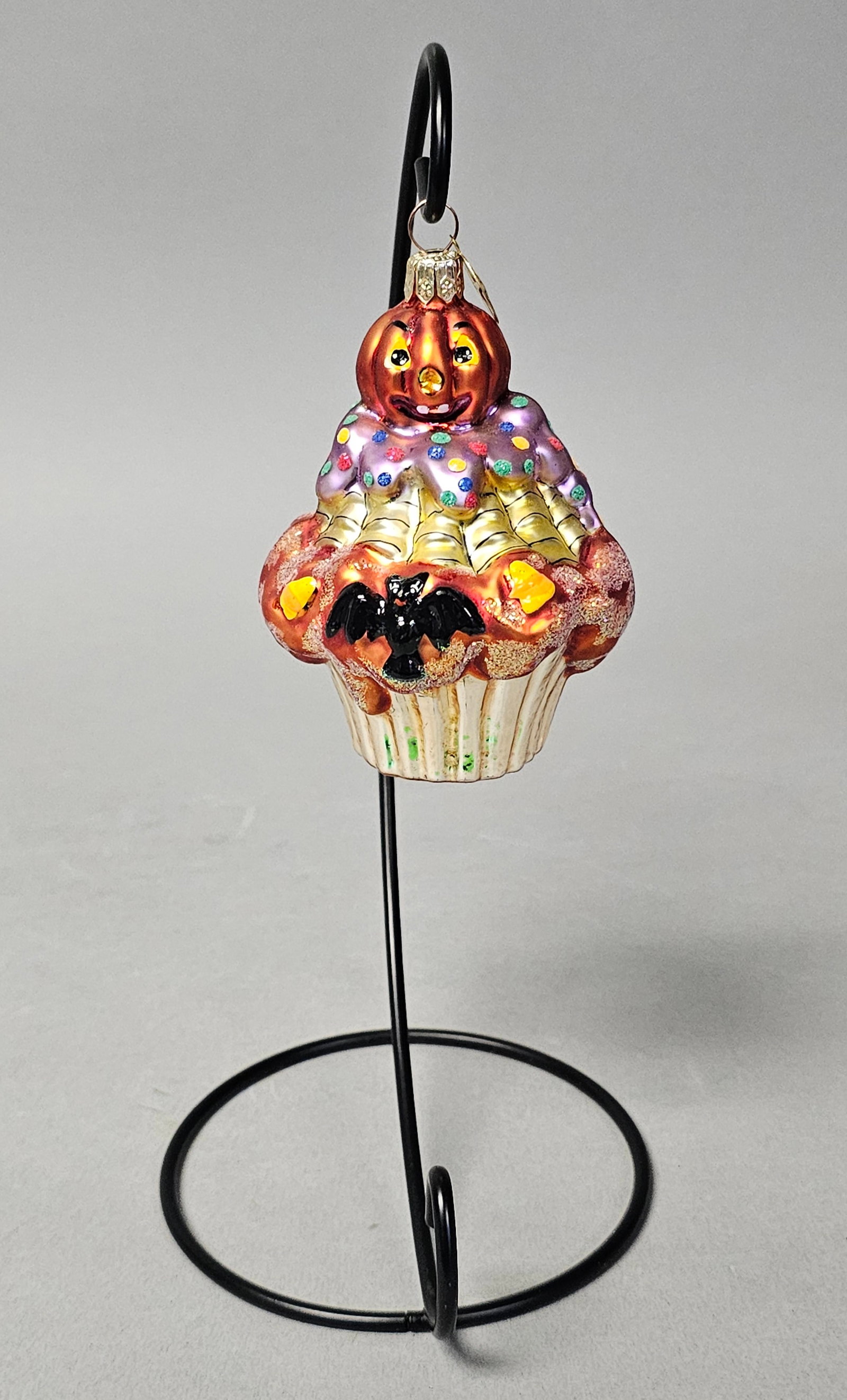 Radko Blown Glass Halloween Cupcake Ornament: *STAND NOT INCLUDED* A mouth-blown glass Halloween ornament produced by Christopher Radko designed in the form of a decorative cupcake. Height: 4 inches. The ornament is in excellent condition with