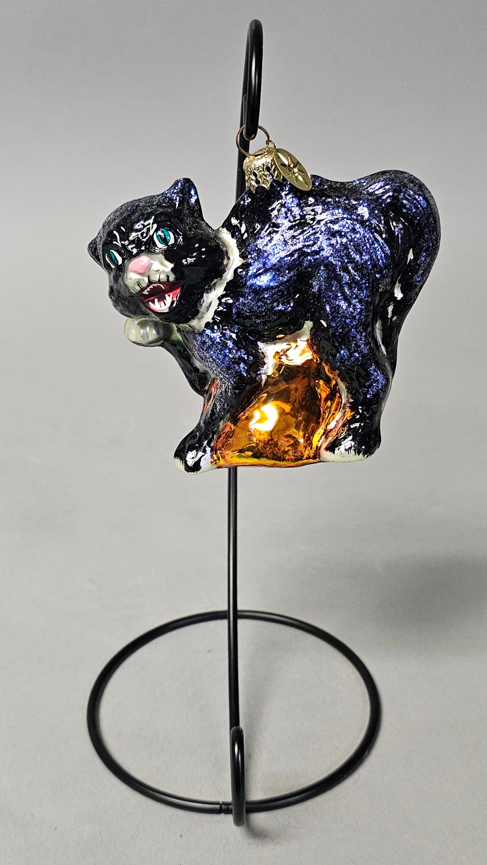 Christopher Radko Black Cat Glass Halloween Ornament: *STAND NOT INCLUDED* A Christopher Radko mouth-blown glass Christmas ornament titled Catastrophic. This piece depicts a black cat in a defensive, arched-back posture. The ornament features a