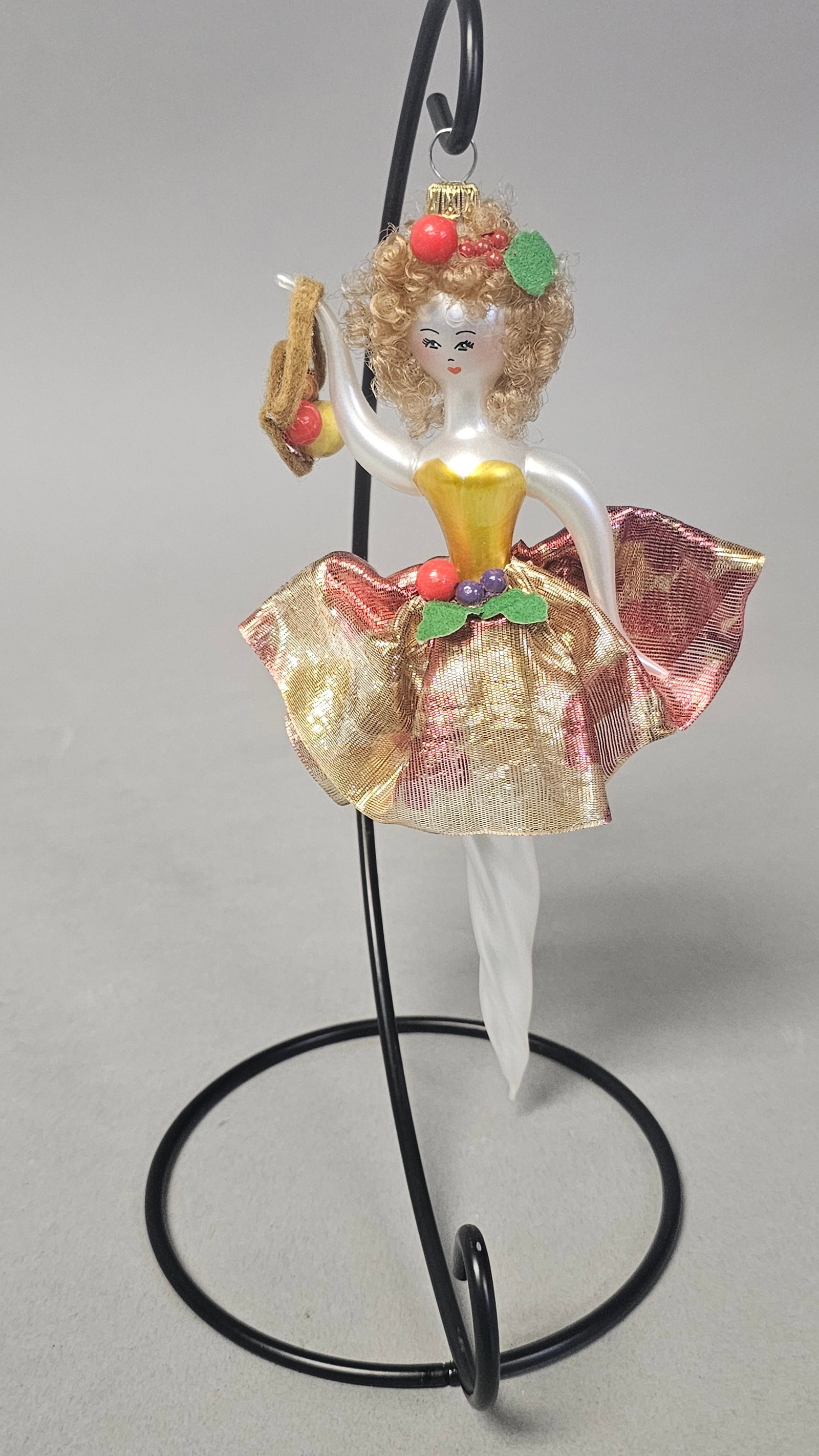 Italian Hand Blown Glass Fruit Woman Ornament: *STAND NOT INCLUDED* This vintage Italian Christmas ornament is crafted from hand-blown glass with an opalescent finish. The figurine depicts a female character, often characterized as a dancer or pea