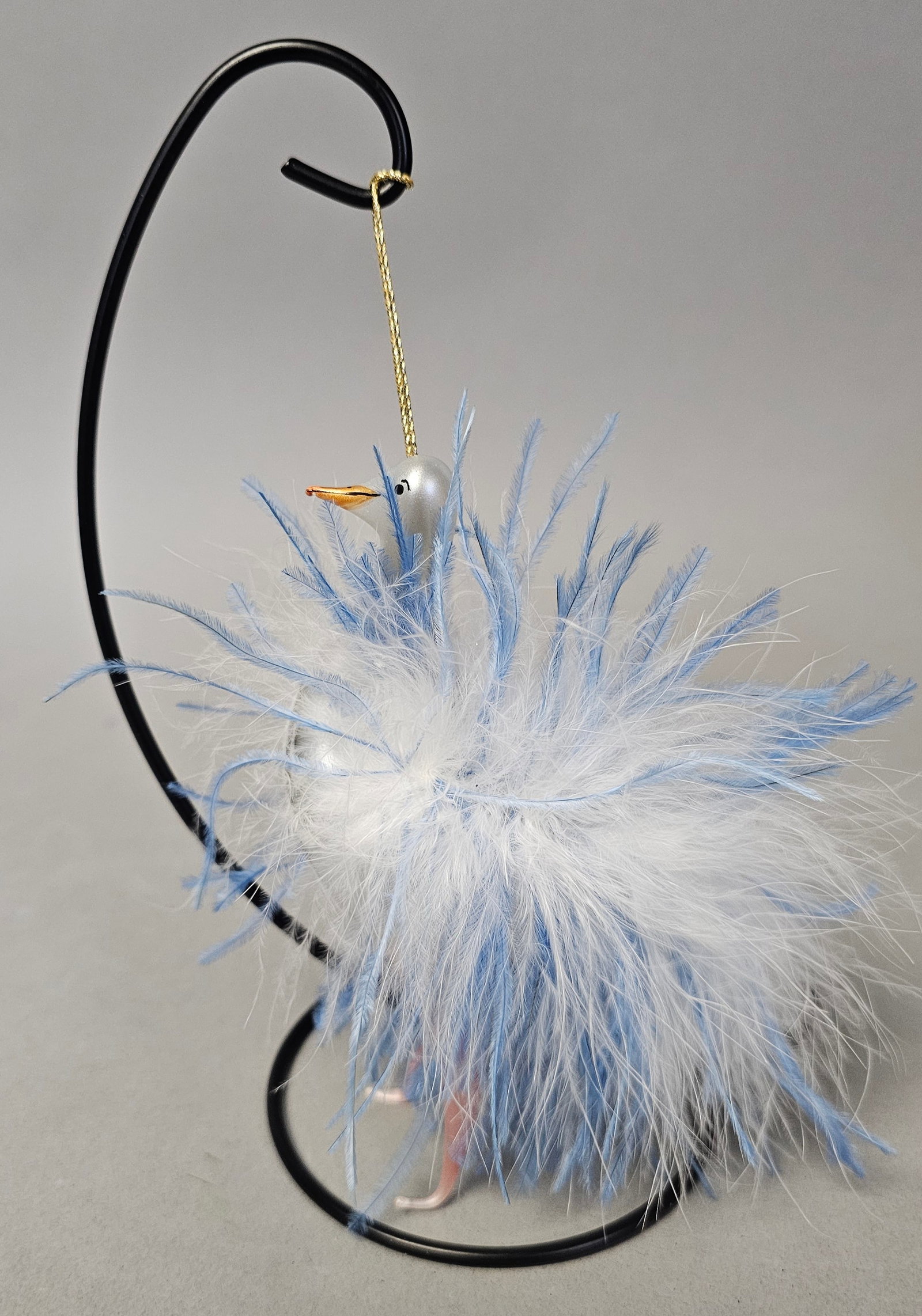 Italian Hand Blown Glass Bird Ornament: *STAND NOT INCLUDED* The piece features a hand-blown glass body with a pearlescent silver-white finish, embellished with a dense layer of white downy feathers and longer blue-tinted feathers. A gold-t