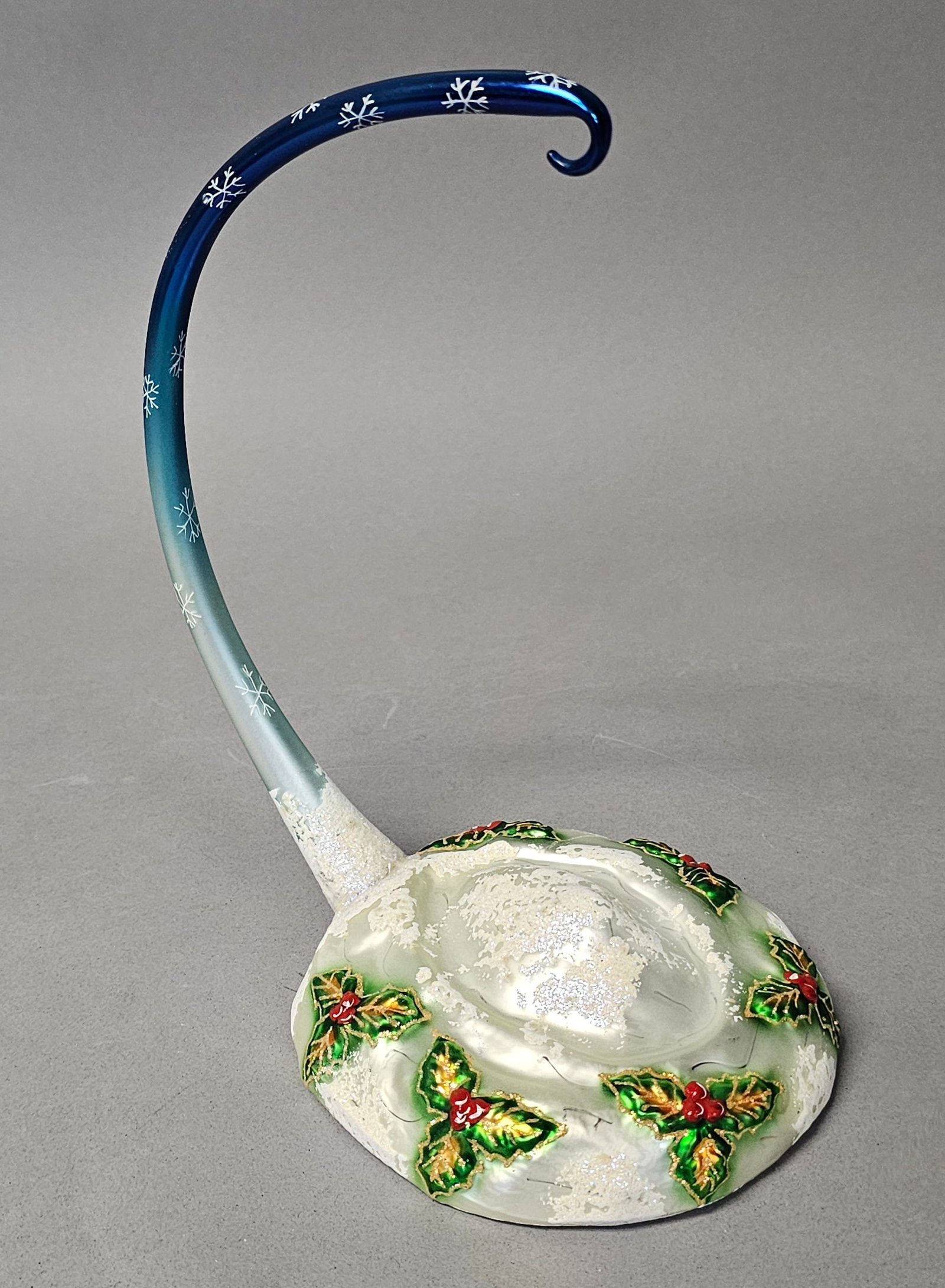 Radko Midnight Magic Pattern Glass Ornament Stand: This glass ornament stand is attributed to the Christopher Radko Midnight Magic collection. It features an elegantly curved glass arm with a gradient color transition starting from a frosted transluce