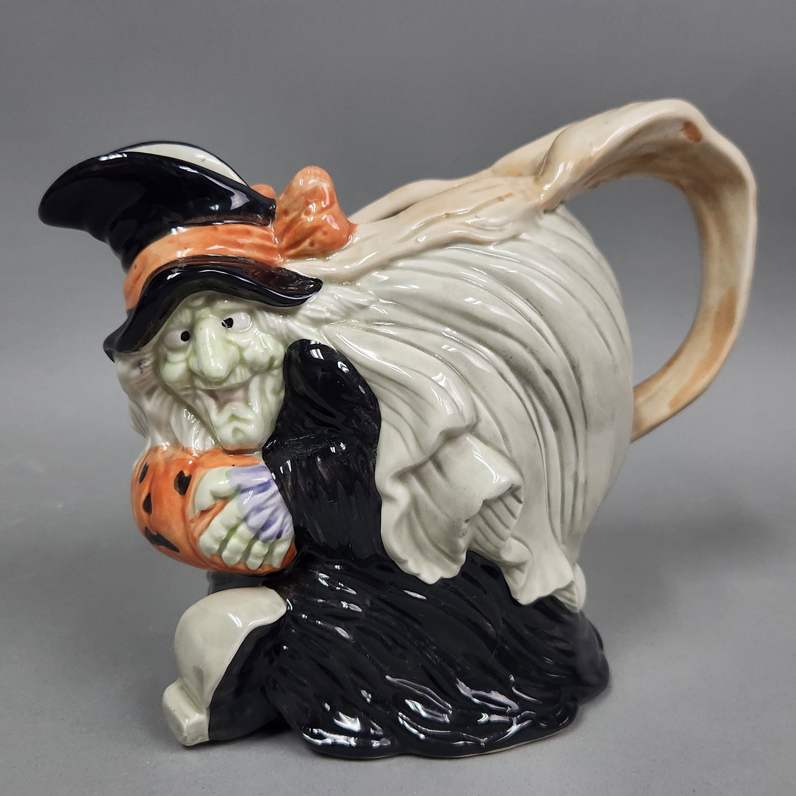 Fitz & Floyd Witch Pitcher: This figural ceramic pitcher, produced by Fitz and Floyd in 1988, is titled "Witch" and features a two-quart capacity intended for decorative or functional use. The pitcher is in good decorative condi