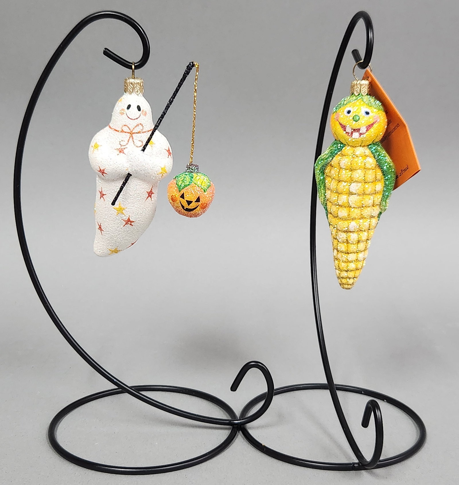 Patricia Breen Halloween Ornaments: Stands not included. This lot features a pair of collectible hand-blown glass ornaments designed by Patricia Breen and handmade in Poland. Ghost Ornament: 4.5 inches Corn Ornament: 5 inches. Both