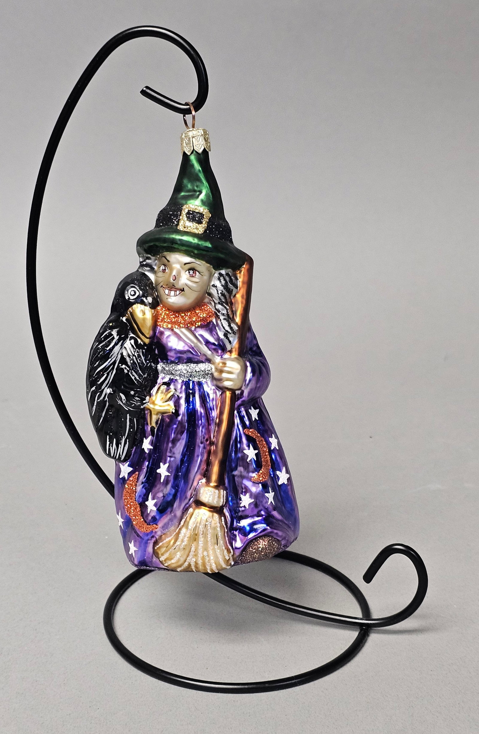 Radko Snaggletooth Witch Halloween Glass Ornament: *STAND NOT INCLUDED* Christopher Radko Snaggletooth Witch Halloween glass ornament. This hand-blown glass figurine depicts a whimsical witch character with a hand-painted snaggle-toothed smile and pin