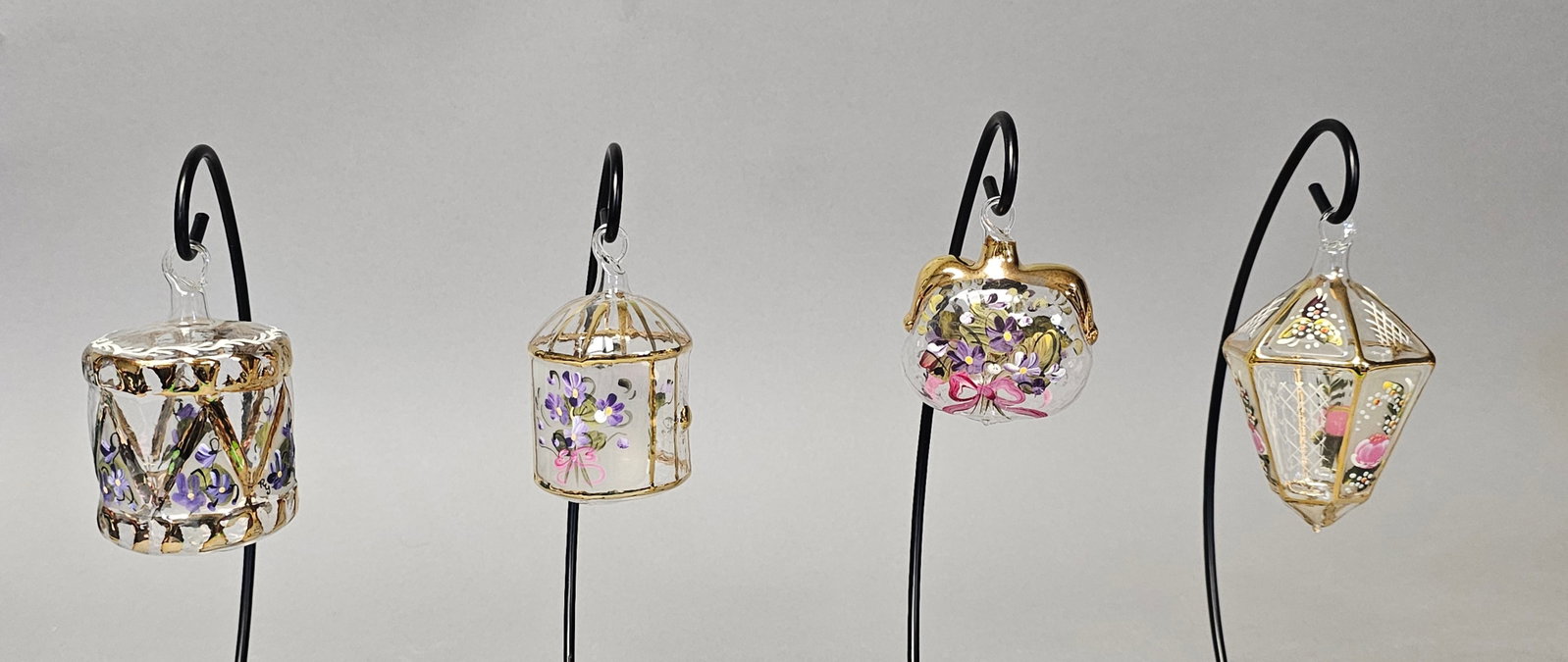 Four Hand-Blown & Hand-Painted Glass Ornaments: *STANDS NOT INCLUDED* A set of four miniature hand-blown glass ornaments dating to the late 20th century, each featuring hand-painted enamel floral motifs and gilded accents Drum: 2.5 inches height Bi