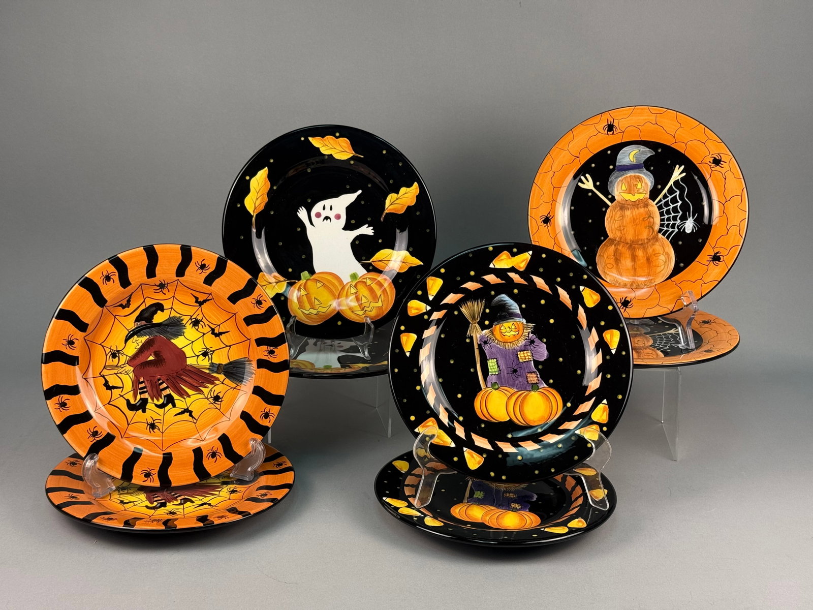 Eight Laurie Gates Ware Halloween Ceramic Salad Plates: A set of eight ceramic salad or dessert plates from the Gates WARE line designed by Laurie Gates. The set comprises two plates each of four distinct illustrative Halloween-themed designs. Each plate h