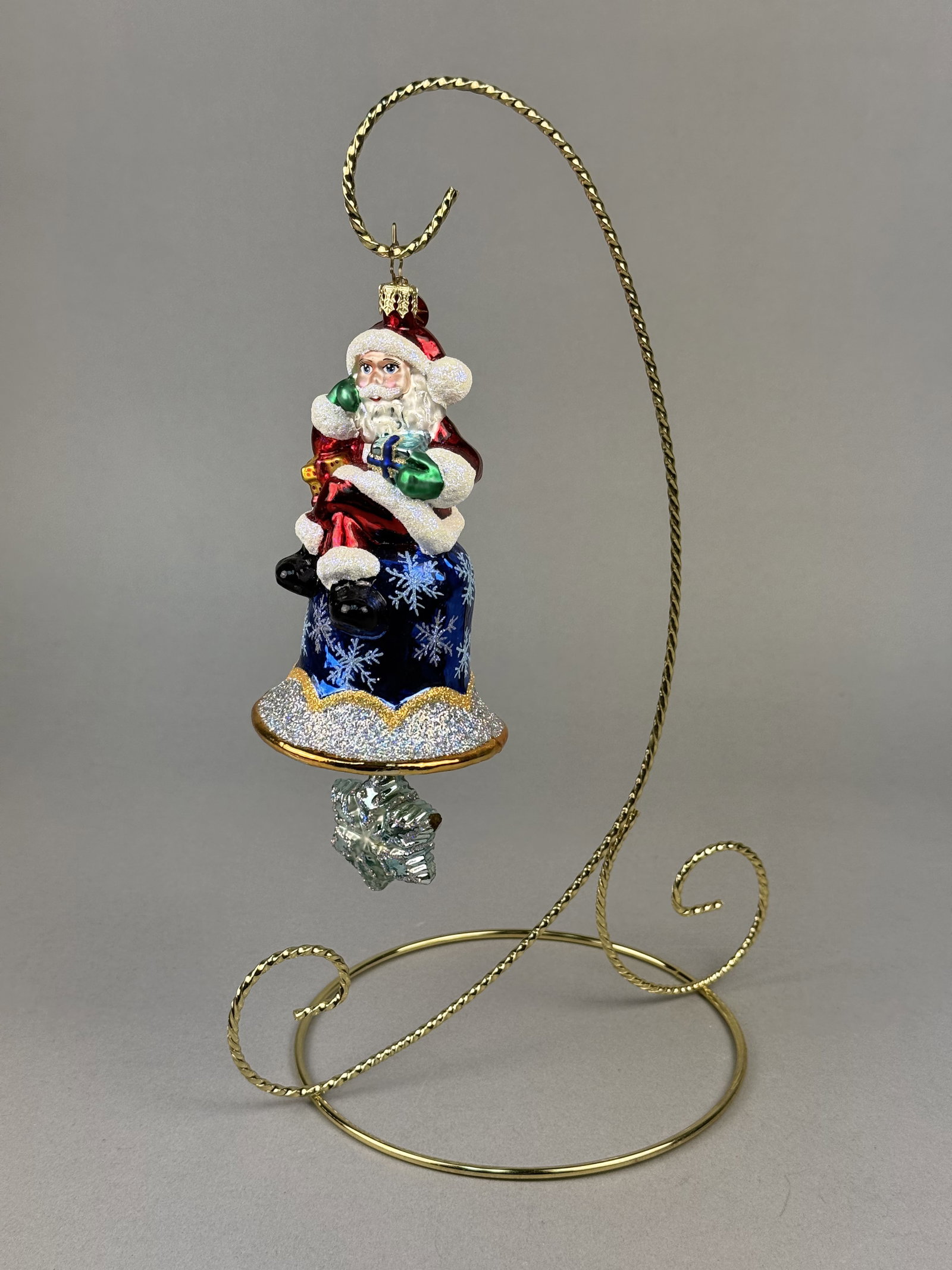 Radko Ring in the Holiday Santa Claus Glass Bell Ornament: Stand not included. This hand-painted, mouth-blown glass Christmas ornament is titled Ring in the Holiday and was produced by Christopher Radko. The ornament is finished with a gold-toned metal cap an