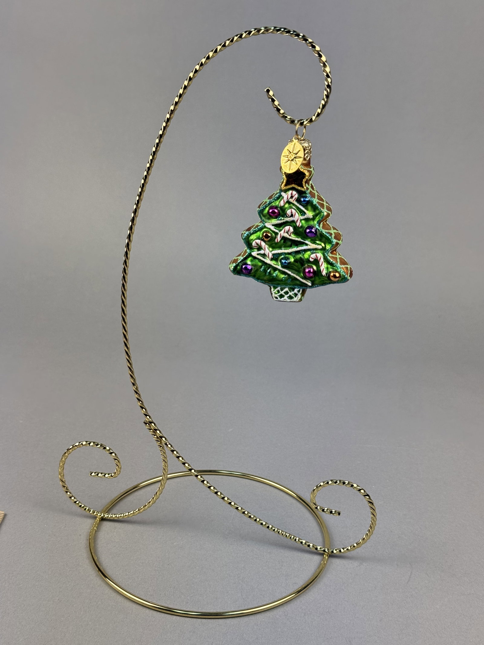 Radko Sweet Ginger Tree Gem Glass Christmas Tree Ornament: Stand not included. A hand-blown glass Christmas tree ornament by Christopher Radko, identified as the Sweet Ginger Tree Gem pattern. Attached to the loop is the signature Christopher Radko oval metal