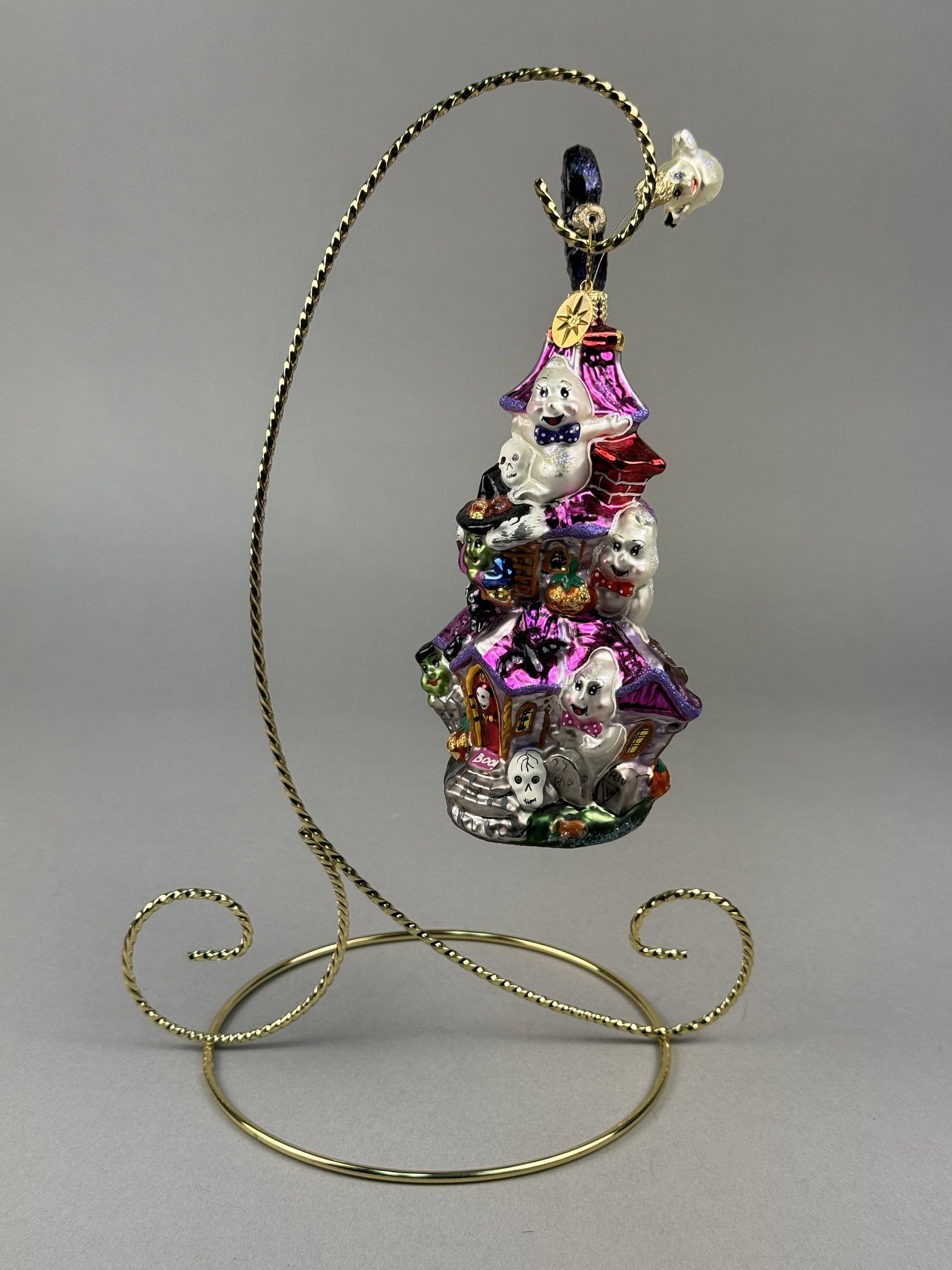 Radko Monster Manor Hand Blown Glass Halloween Ornament: Stand not included. A large hand-blown glass Halloween ornament by Christopher Radko, identified as the Monster Manor pattern. Attached to the hanging loop is the signature Christopher Radko gold-tone