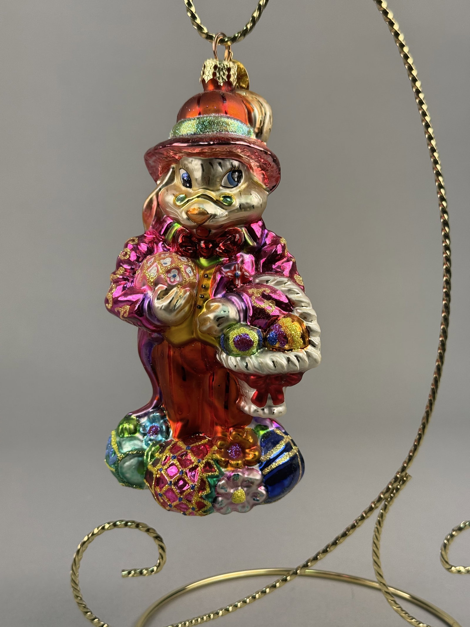 Radko Dapper Hare Hand-Blown Glass Easter Bunny Ornament: Stand not included. A hand-blown glass ornament by Christopher Radko, identified as the Dapper Hare model. The item features the signature Christopher Radko eight-pointed star metal charm attached to 