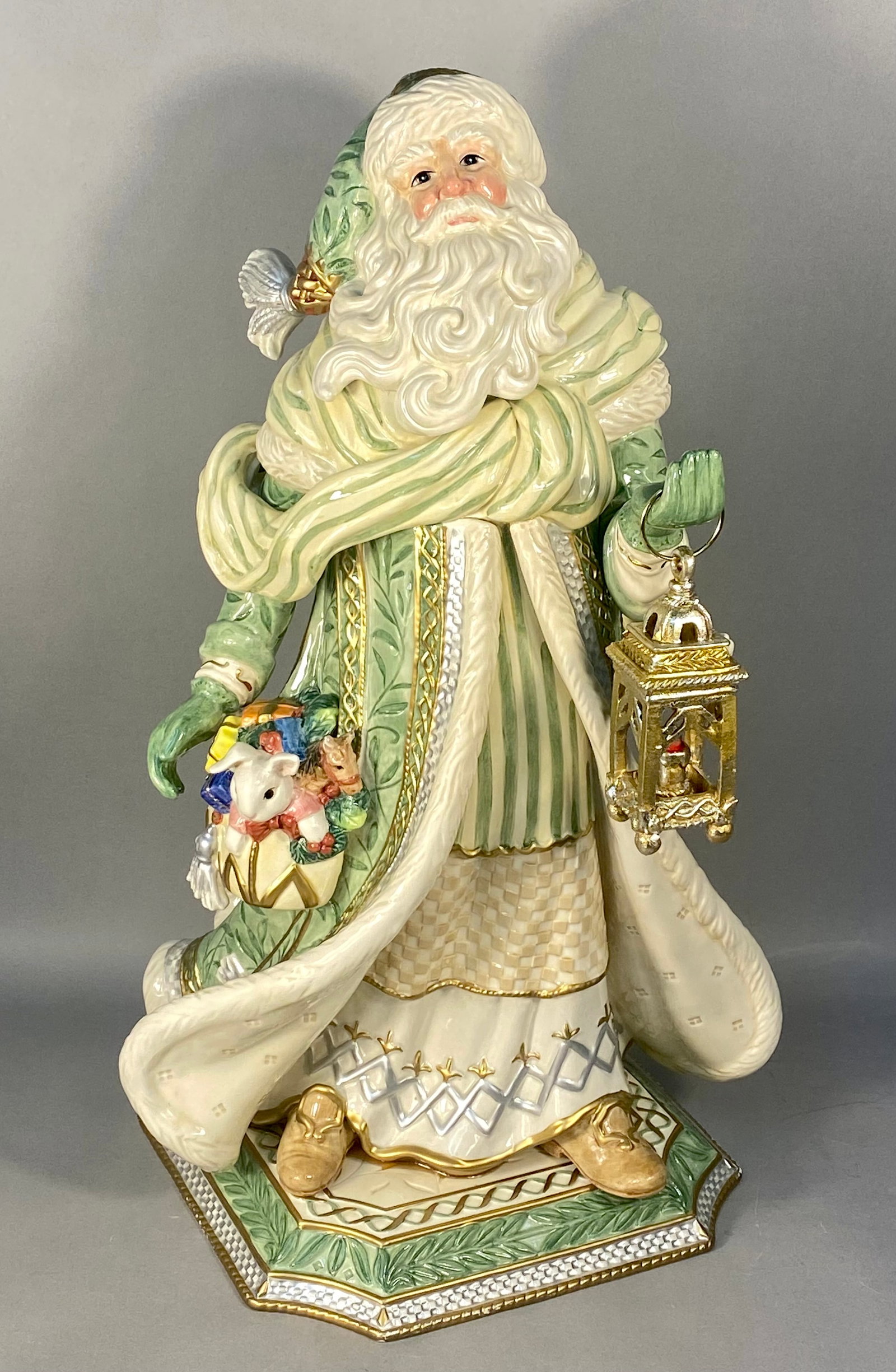 Fitz and Floyd Gregorian Collection Large Santa Figurine: A large handcrafted porcelain Santa Claus figurine from the Fitz and Floyd Gregorian Collection. The figure is depicted in a regal standing pose, wearing layered robes of pale sage green and cream