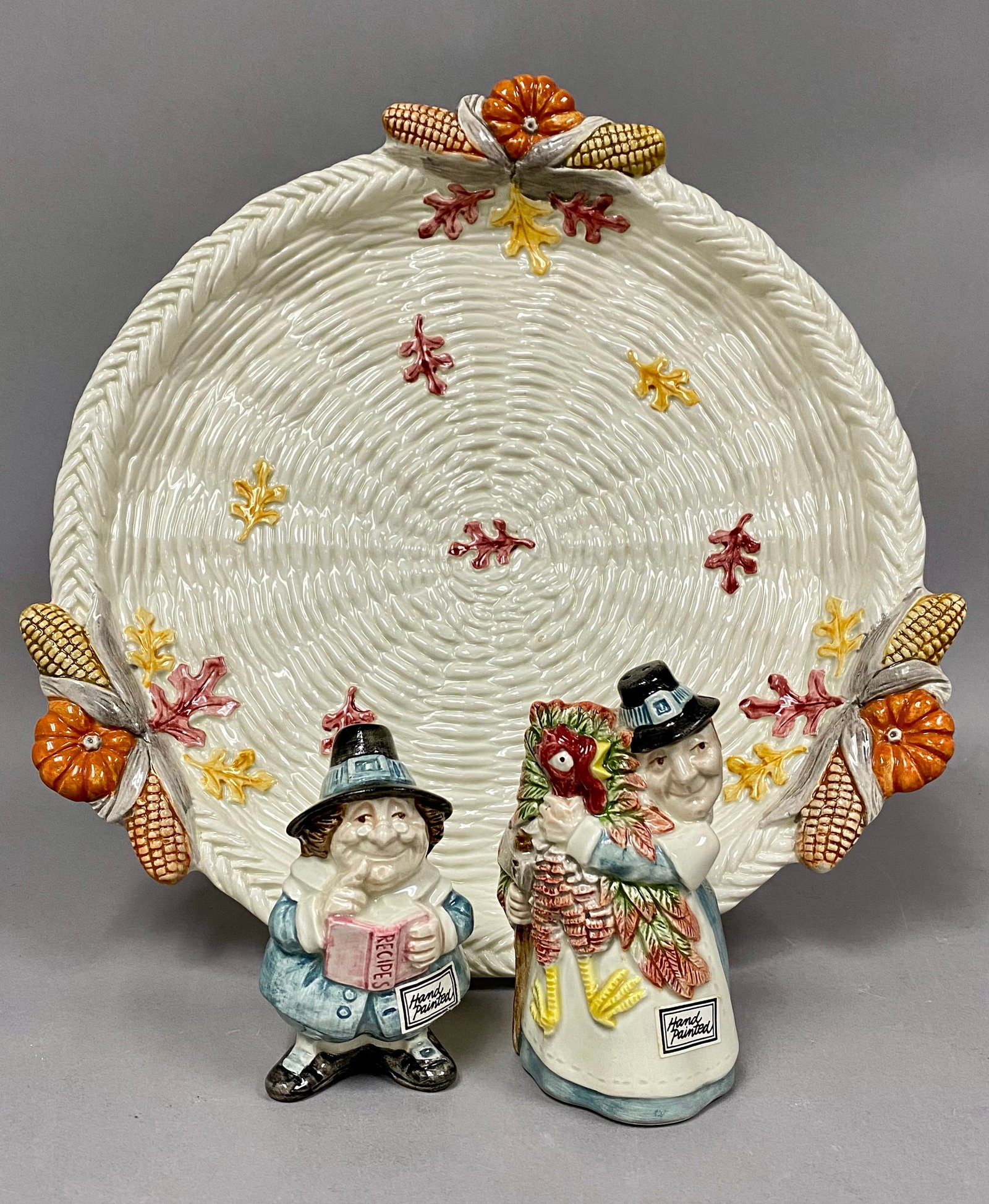 Fitz and Floyd Pilgrim's Progress Platter and Shaker Set: A collection of Fitz and Floyd ceramics in the Pilgrims Progress pattern, dated 1990. The set includes a large round serving platter and a pair of figural salt and pepper shakers. The platter is desig