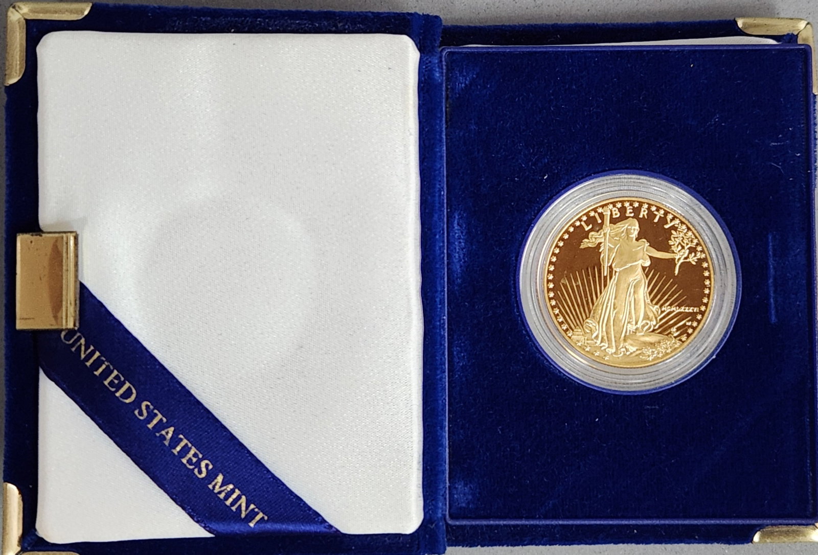 1986-W $50 Gold Eagle Coin 33.93 Grams: 1986-W US $50 American Gold Eagle proof coin. This piece was struck at the West Point Mint and contains one ounce of fine gold. The obverse features the Saint-Gaudens Walking Liberty design type with 