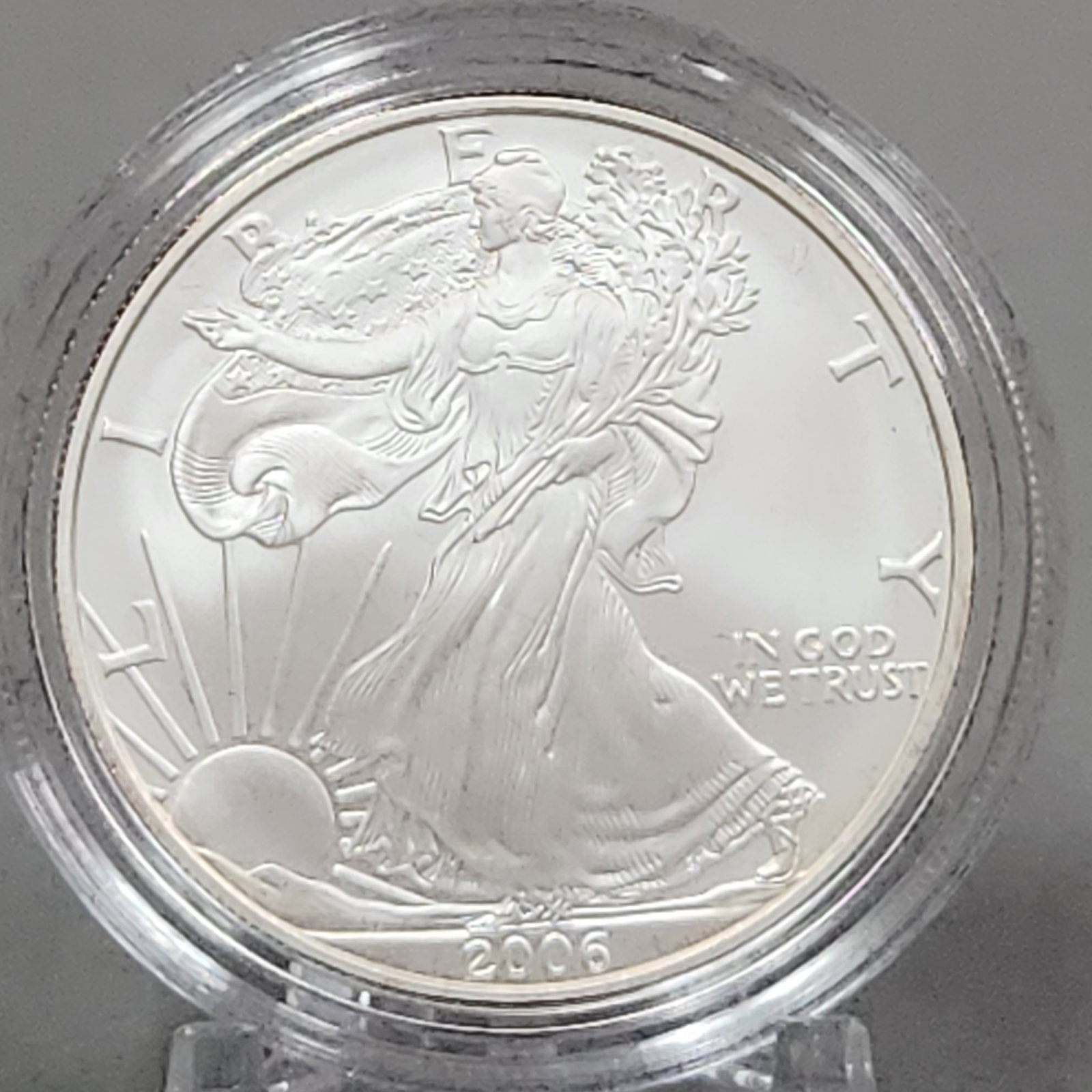2006-W Eagle Silver Uncirculated Coin 40 Grams: This 2006-W American Eagle one ounce silver uncirculated coin was struck at the West Point Mint. The coin is composed of .999 fine silver and carries a legal tender face value of one dollar. It featur