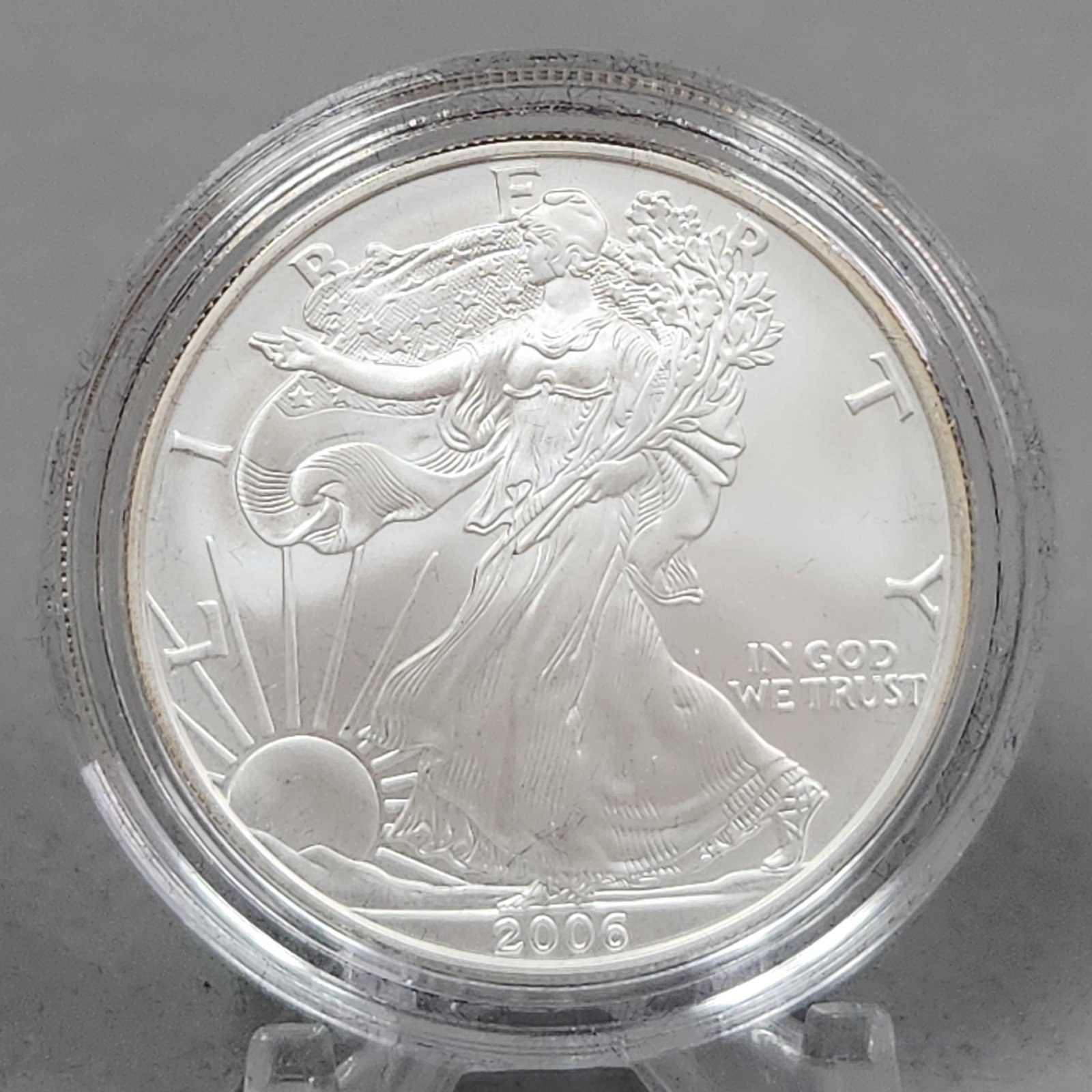 2006-W $1 Eagle Uncirculated Coin 31 Grams: 2006 American Eagle one-ounce silver uncirculated coin issued by the US Mint. Struck in .999 fine silver with a one-dollar denomination, this coin features the Walking Liberty obverse and the heraldic