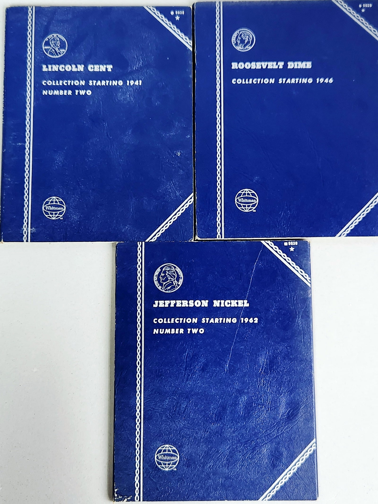 1941-1968 Coin Collection Folders: A trio of blue Whitman coin folders containing an assortment of United States coinage. All are incomplete. The collection includes a Lincoln Cent folder (No. 9030) for coins starting in 1941, a Jeffer