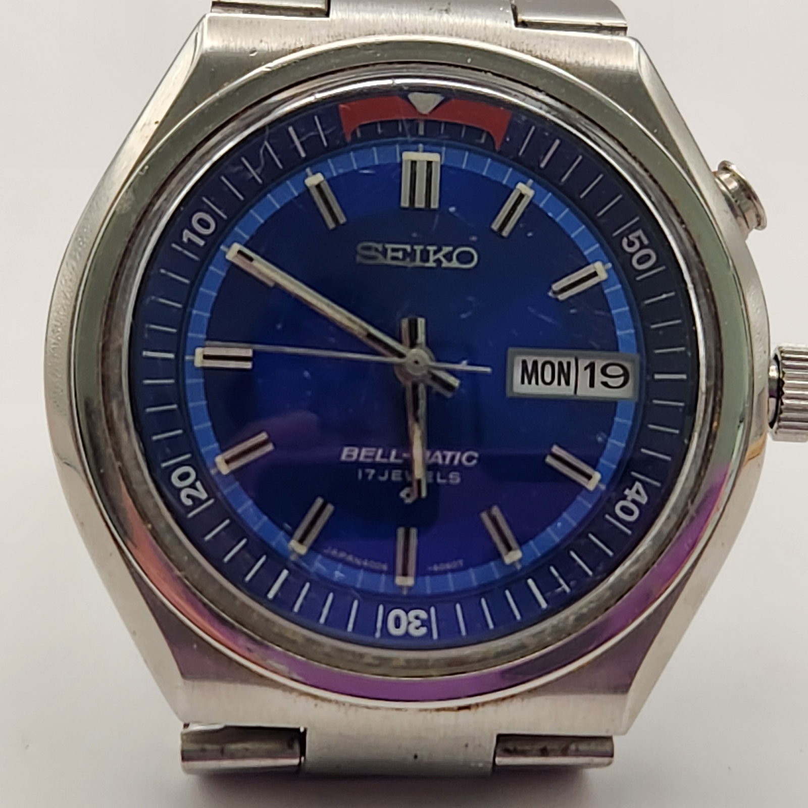 Seiko Bell-Matic Automatic Alarm Watch #4006-6049: This vintage Seiko Bell-Matic wristwatch features a stainless steel case and a sunburst blue dial. It is powered by a 17-jewel automatic movement, caliber 4006. The screw-down caseback is stamped with