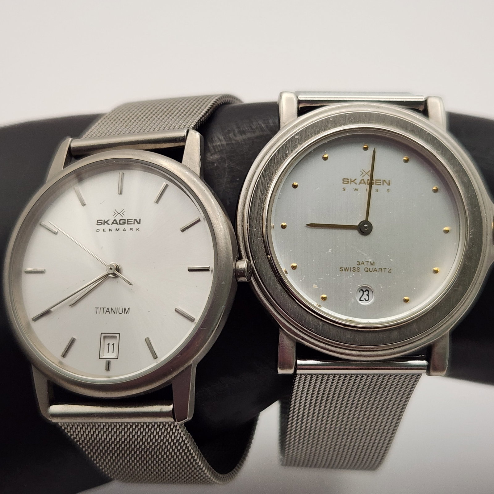 Skagen Ultra Slim Mesh Band Watches: The first watch is a Skagen Swiss model, reference B26LSS. The case back is inscribed SKAGEN SWISS, B26LSS, ULTRA SLIM SWISS ETA MOVT. JORST INT'L DENMARK CASE SS. WATER RESISTANT 100FT. The second wa