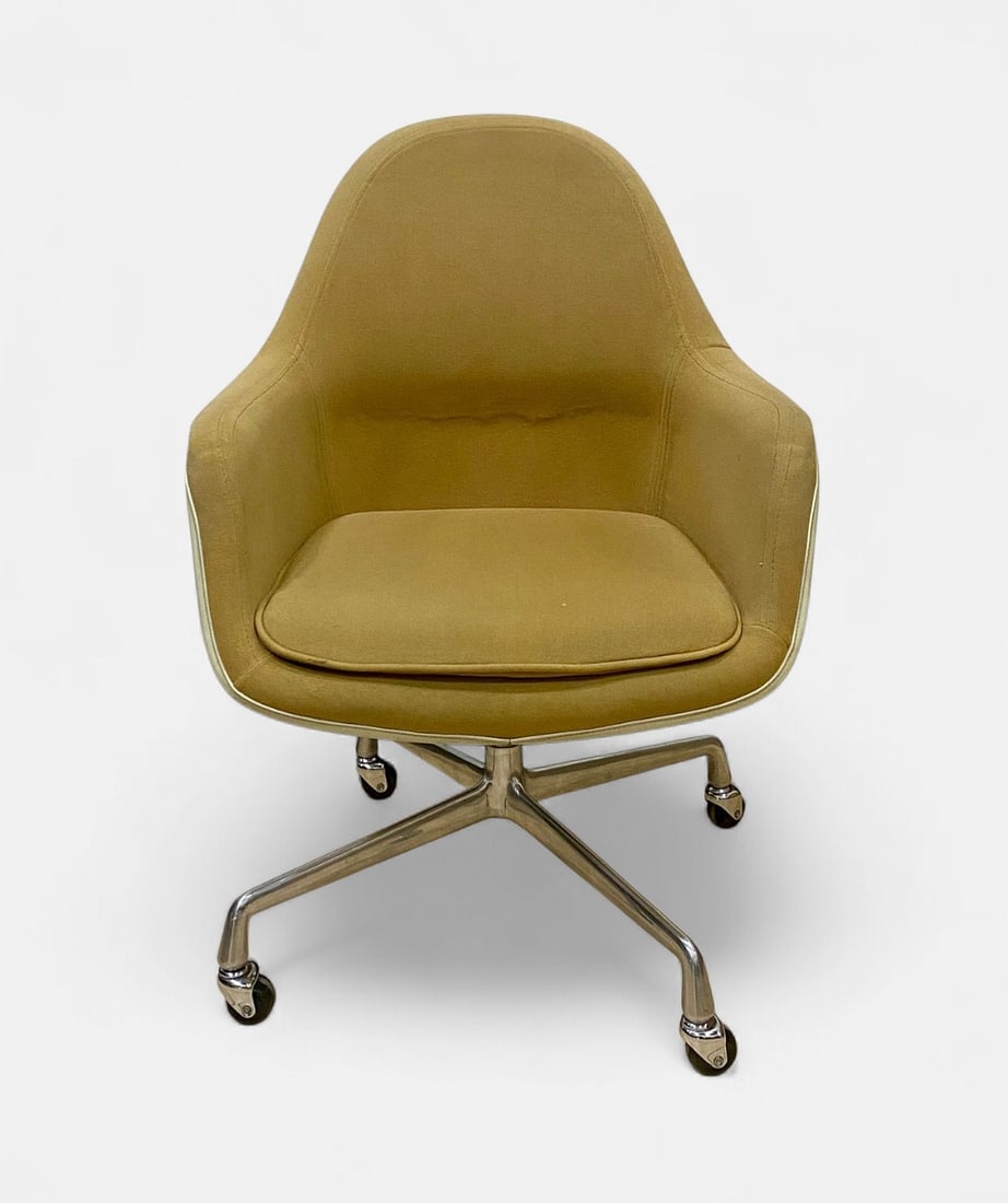 Eames for Herman Miller Fiberglass Shell Armchair: An authentic Charles and Ray Eames for Herman Miller EC175 upholstered fiberglass shell armchair. The chair features a molded cream-colored fiberglass shell with a fully upholstered interior in a text