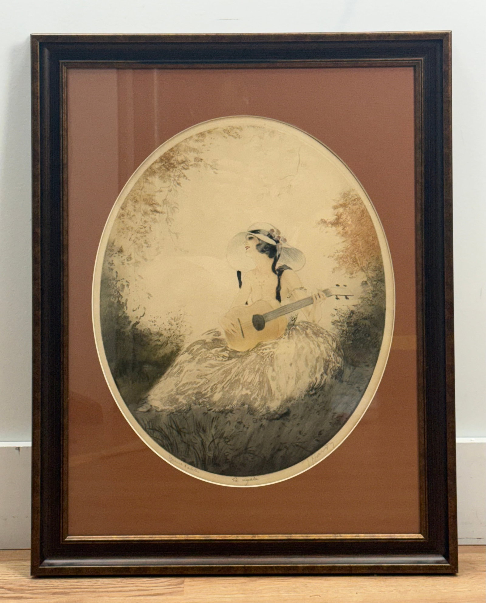 Jean Hardy, La Cigale, Etching and Drypoint Artist Proof: This hand-colored etching and drypoint by French artist Jean Hardy depicts an elegant woman in Art Deco attire seated in a garden landscape while playing a guitar. The subject is rendered with fine li