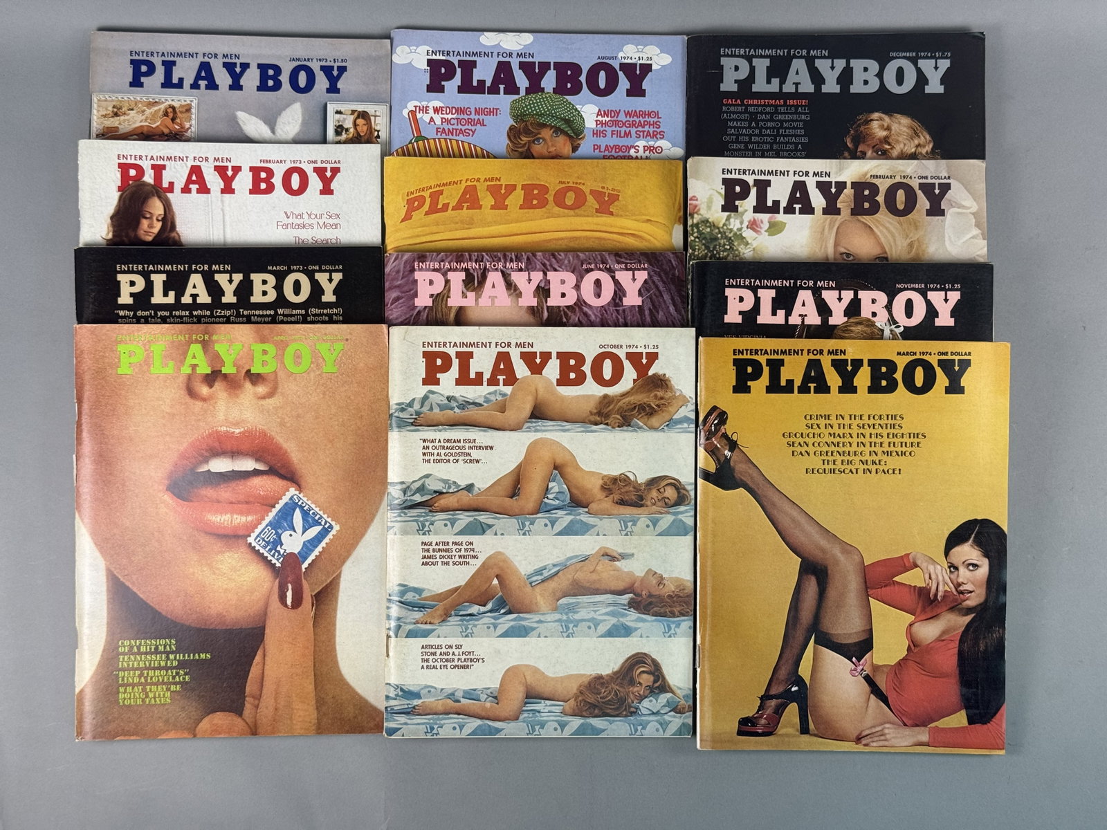 Twelve Vintage Playboy Magazines, 1973-1974: This lot consists of a collection of 12 vintage Playboy magazines published by Playboy Enterprises, Inc., Chicago, Illinois. The assortment includes four issues from 1973 (January, February, March, an