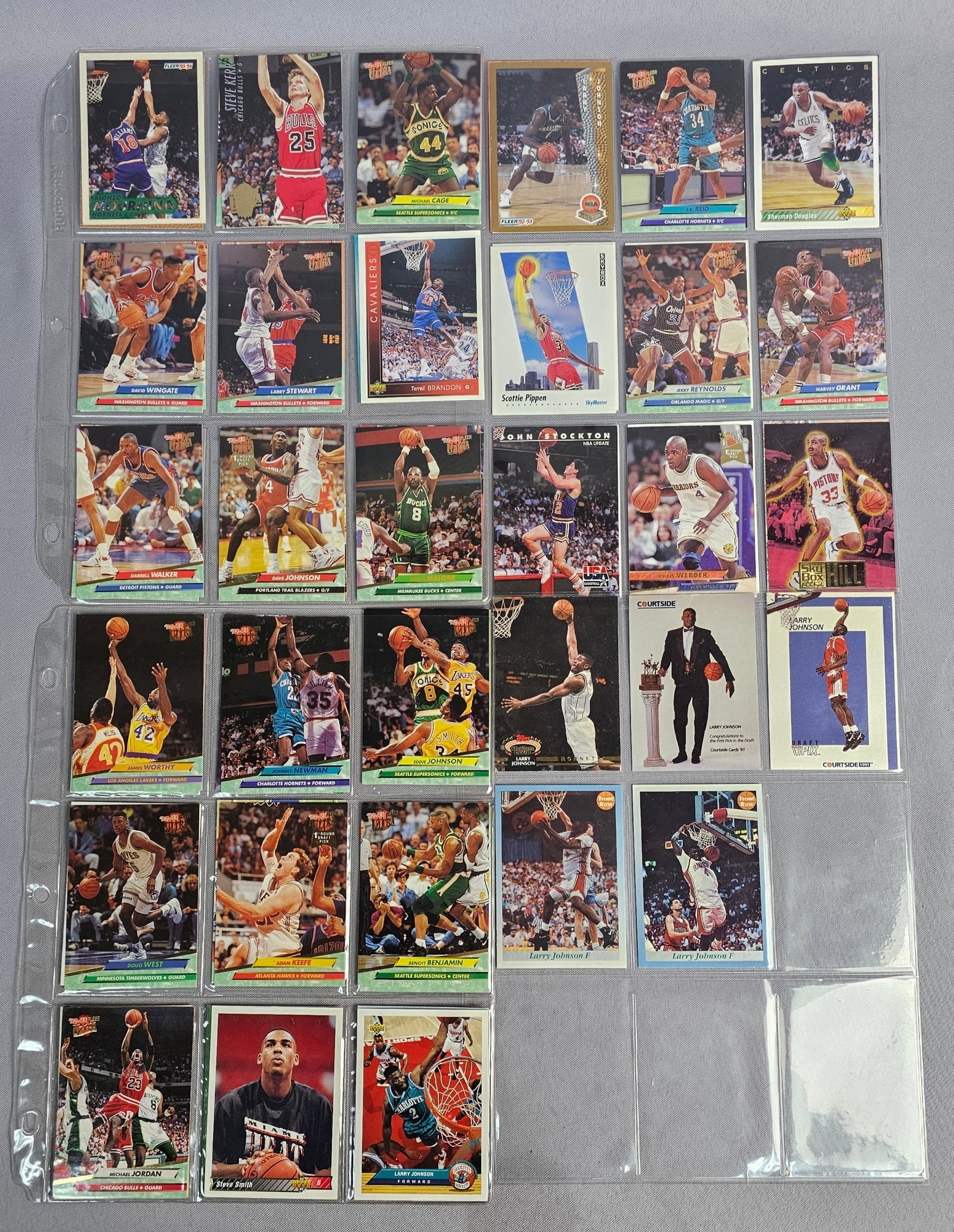 Collection of NBA Basketball Trading Cards: This lot consists of approximately 60 professional basketball trading cards produced between 1991 and 1997. The collection includes various manufacturers such as Fleer, Fleer Ultra, Upper Deck, SkyBox