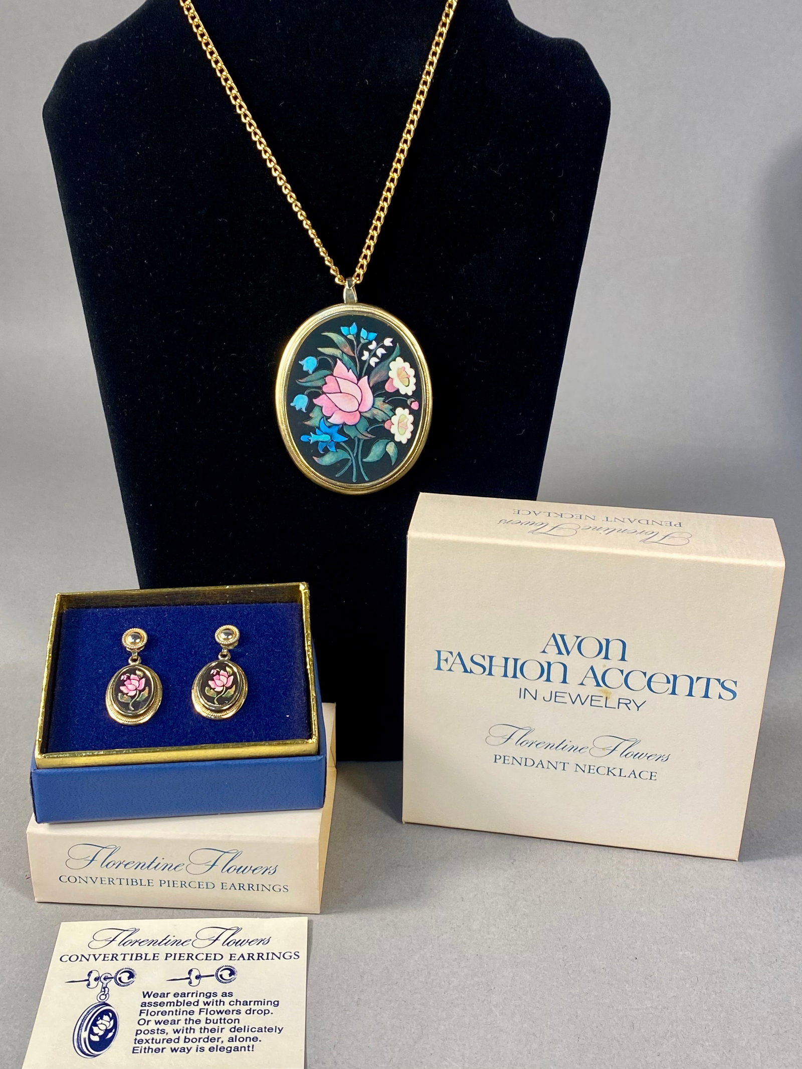 Avon 1974 Florentine Flowers Pendant Necklace & Earrings: This vintage costume jewelry set by Avon, from the 1974 Florentine Flowers collection, consists of a pendant necklace and matching convertible pierced earrings. The oval pendant features a colorful fl